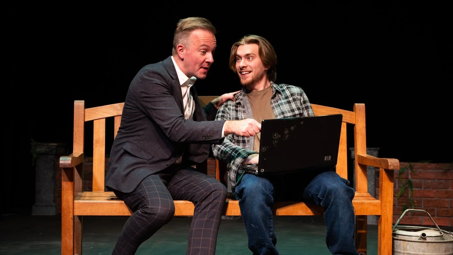 Jamie excitedly points to the laptop as Tommy smiles in the New England premiere of Joe Bravaco's The One Good Thing at Seven Angels Theatre