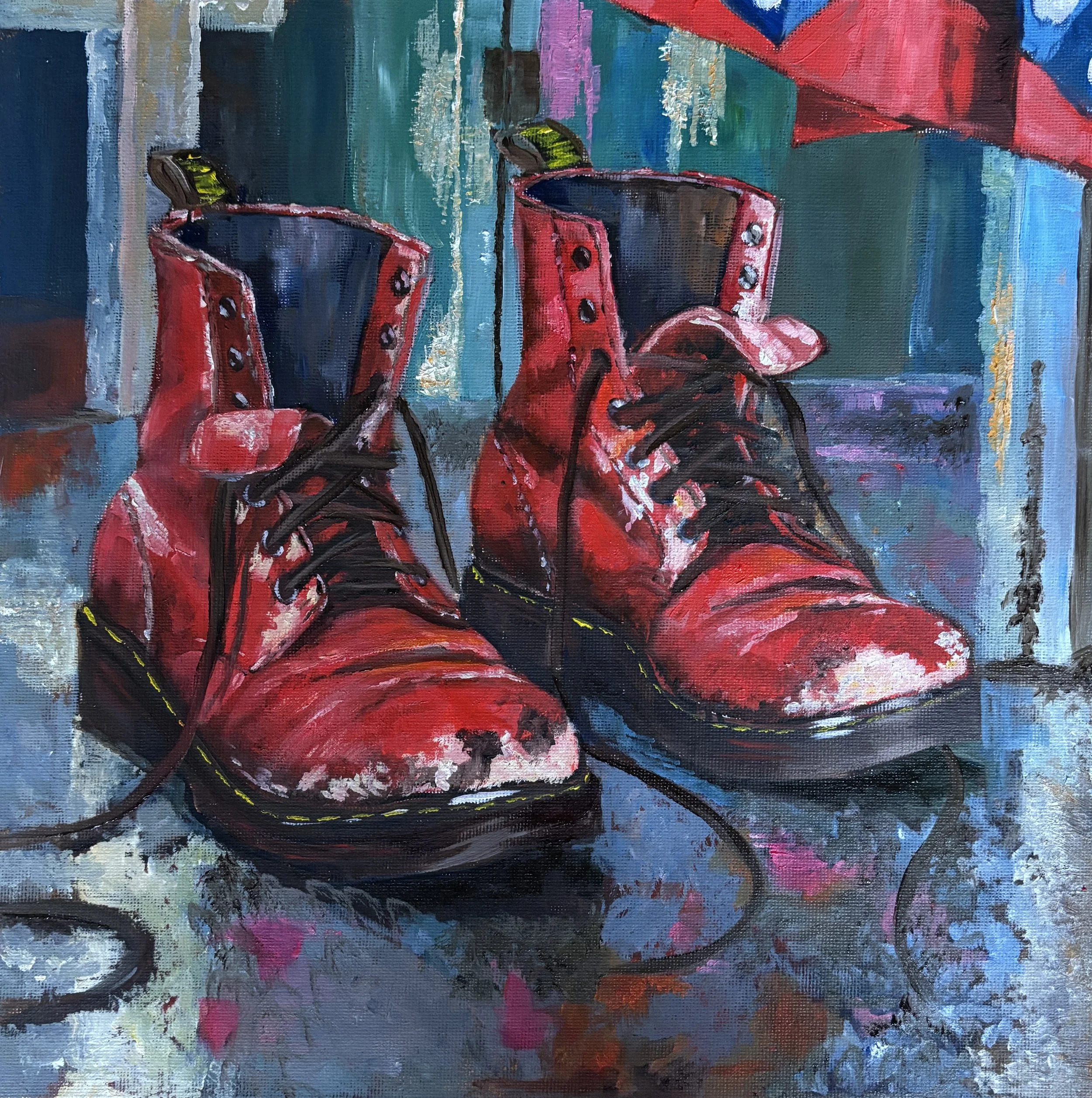Painting of worn red lace-up boots with scuffed toes and loose black laces, reflected on a blue dressing-room floor beneath a colourful costume.