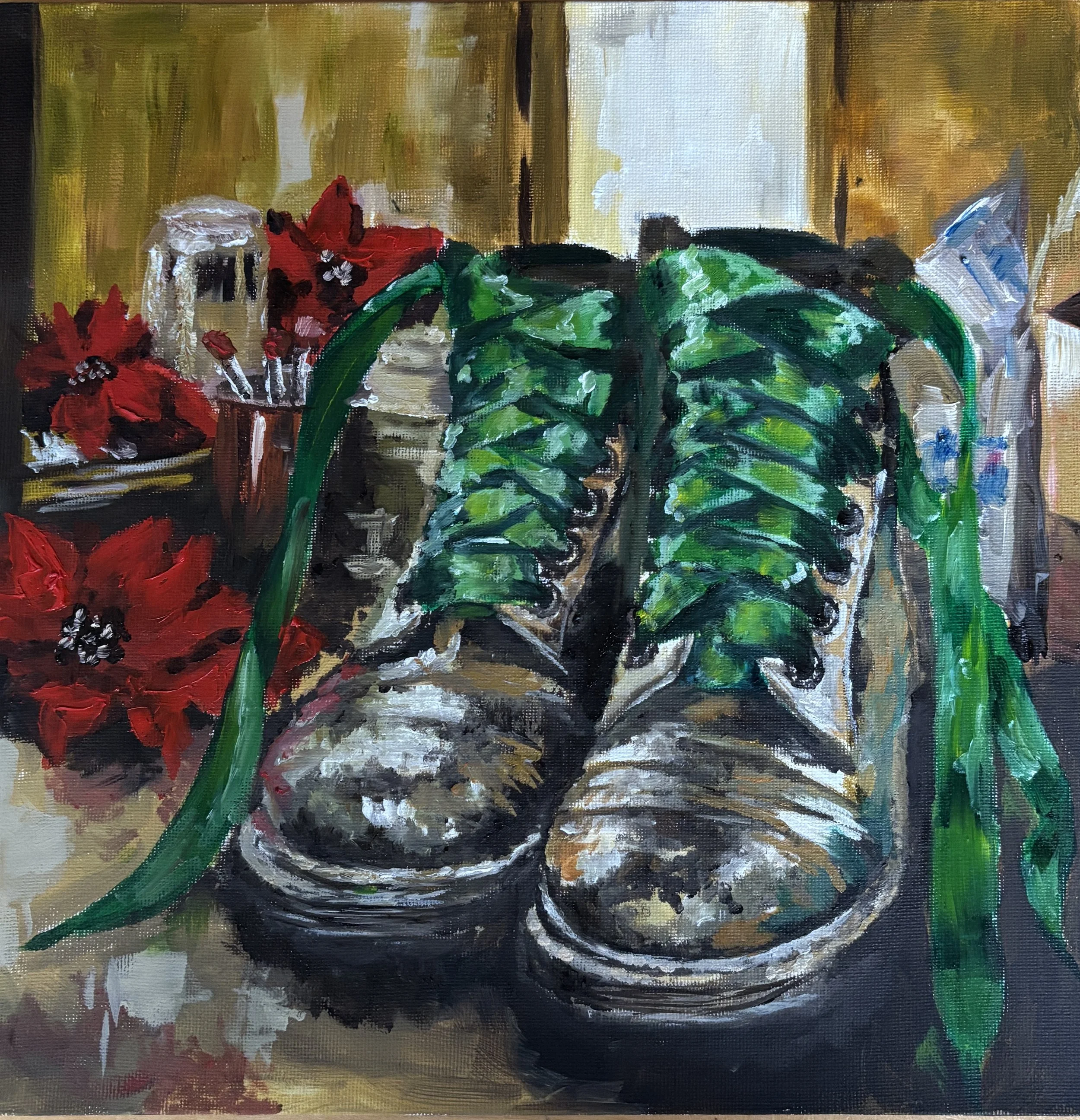 Painting of gold boots with bright green ribbon laces on a dressing table, surrounded by red flowers, make-up brushes and toiletries.