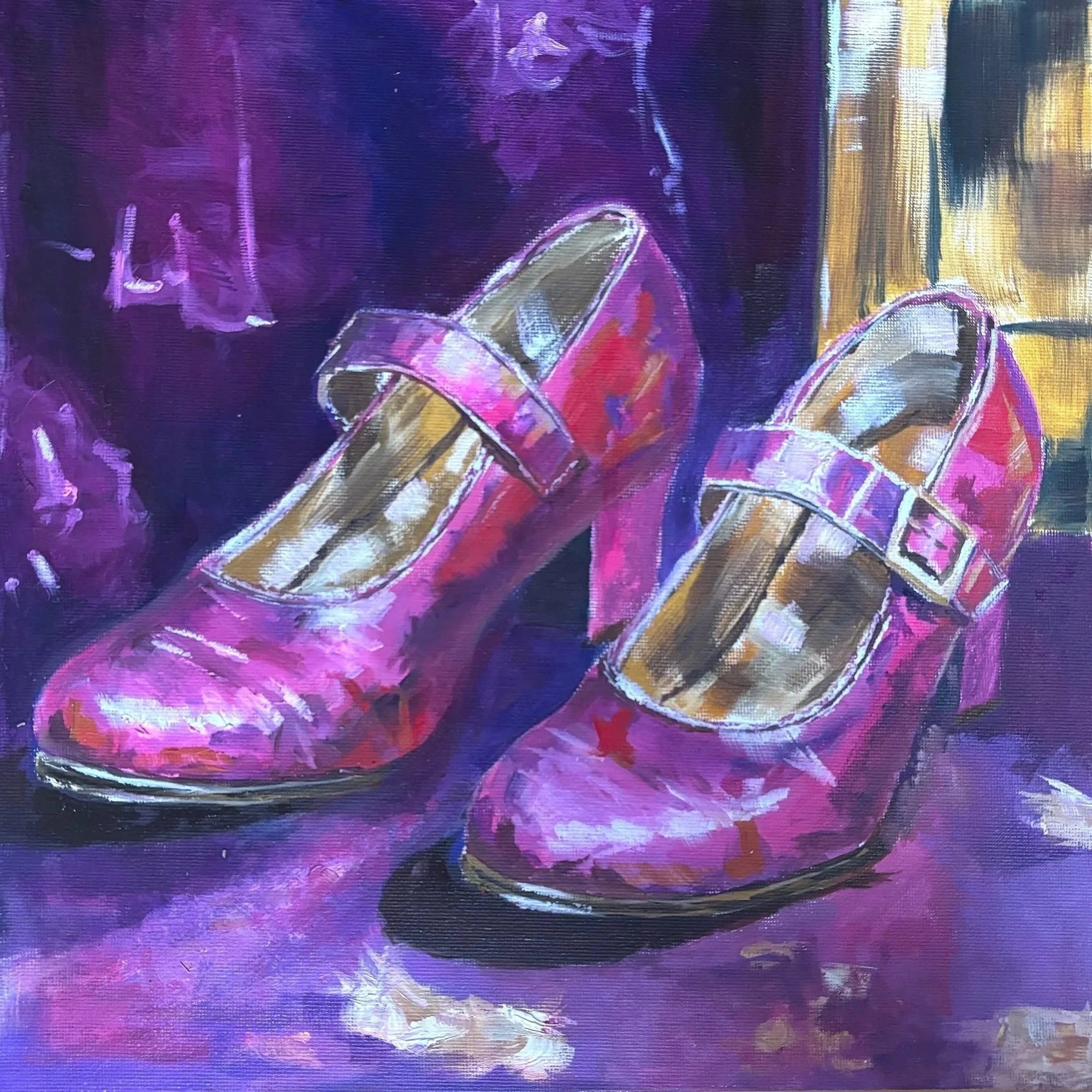 Painting of pink patterned Mary Jane heels with buckled straps, resting on purple fabric beside a gold-framed mirror.