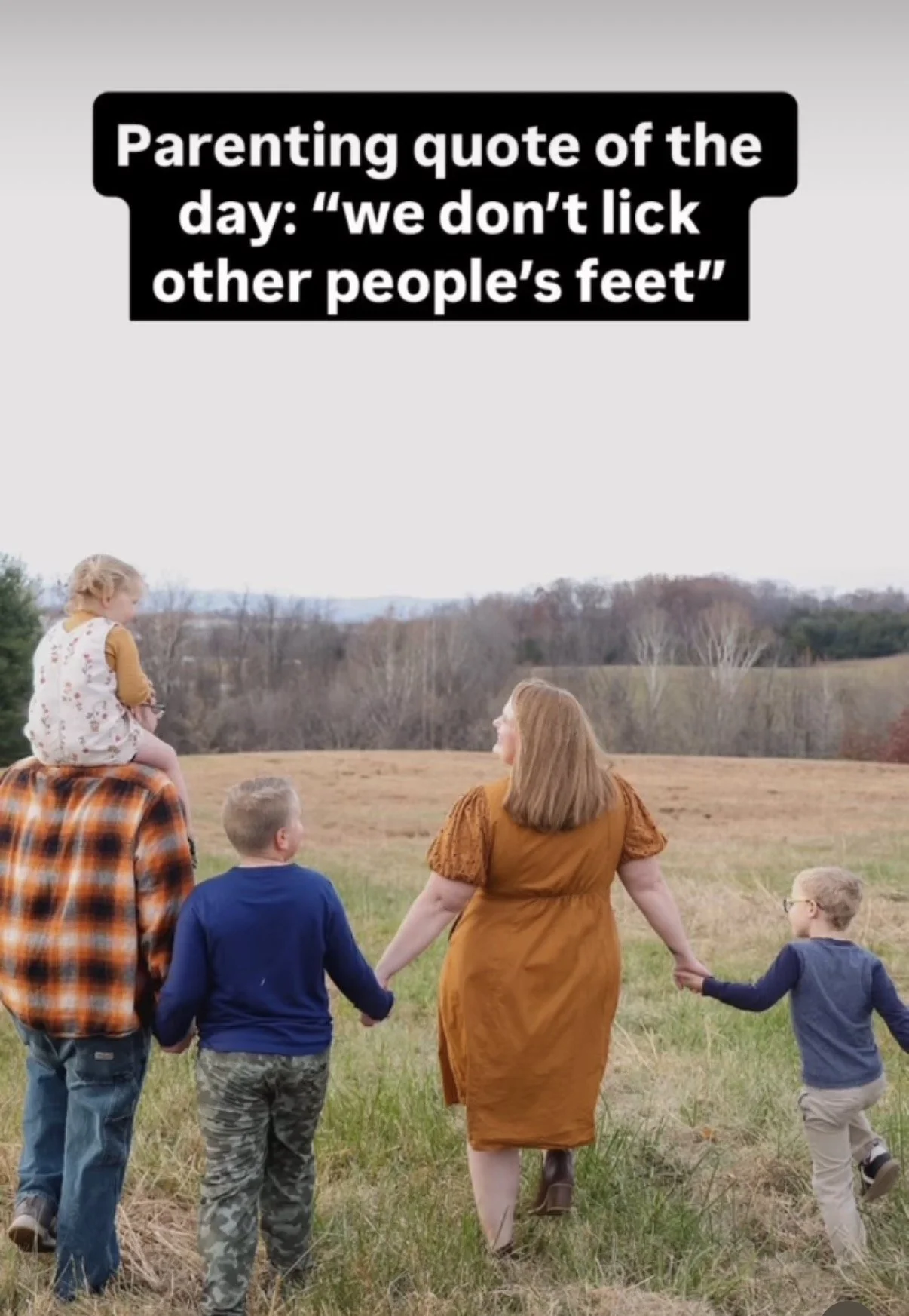 A woman and four children walking hand-in-hand through a grassy field in autumn, with a school quote in a black box at the top that says, 'Parenting quote of the day: 'we don't lick other people's feet''.