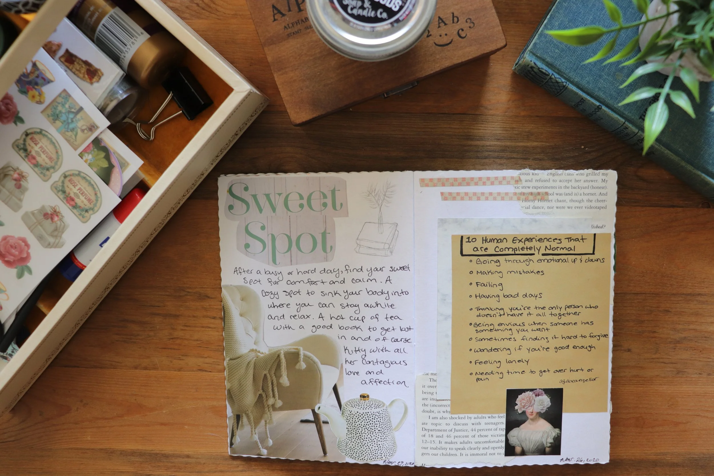 A cluttered wooden desk with various items, including a box of decorative stickers, a notebook or flyer titled 'Sweet Spot', a small jar, a book, and a potted plant.