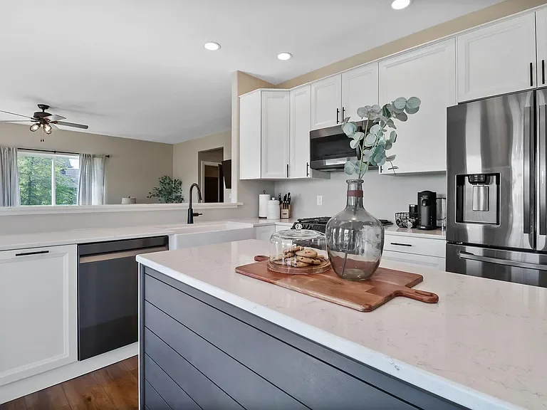 Kitchen renovation, including cabinets and hardware, farmhouse sink, quartz countertops, and a new island with shiplap detailing