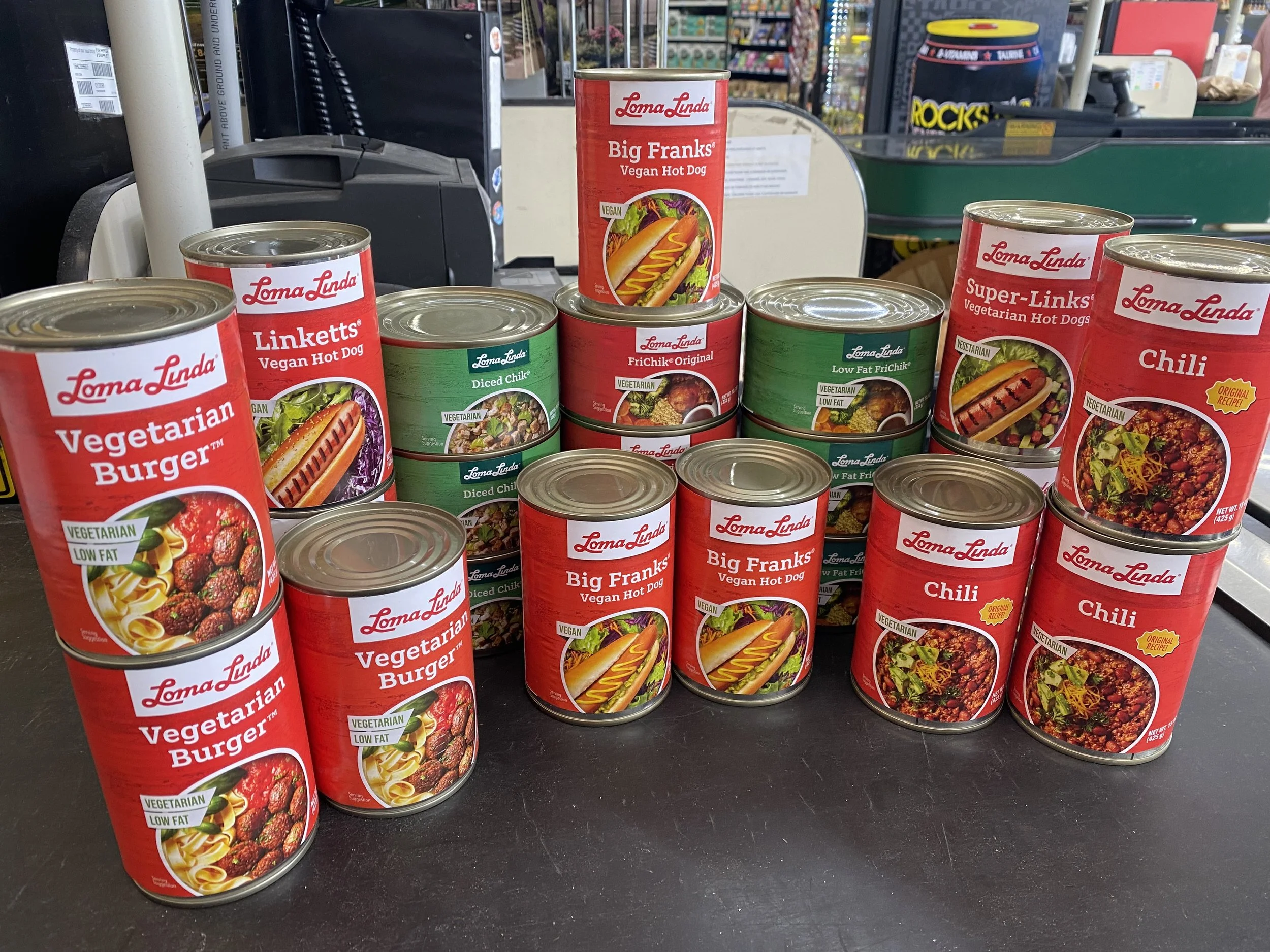 Stacked cans of vegetarian vegan hot dog products at Andy's Market.