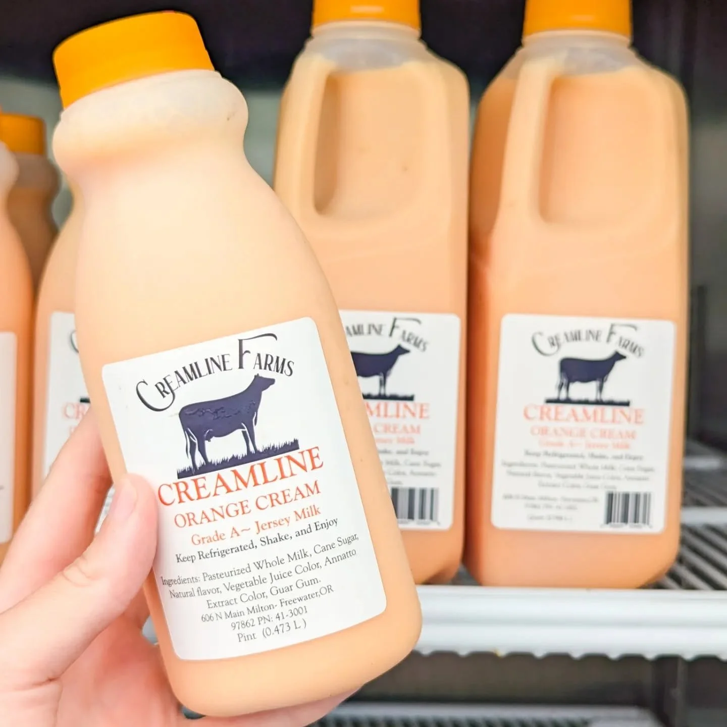 Bottles of Dreamline Farms Creamline Orange Cream Jersey Milk.
