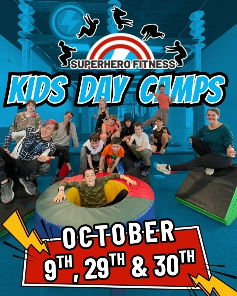 Children and adults participating in superhero-themed fitness camp at a gym, with gym equipment and dynamic graphics promoting 'Kids Day Camps' on October 9th, 29th, and 30th.