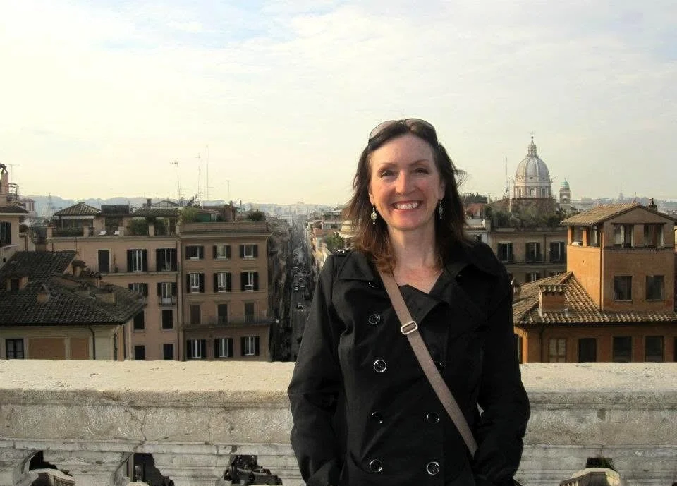 Sandy of Wholehearted Horizons Travel overlooking the rooftops of Rome, Italy.