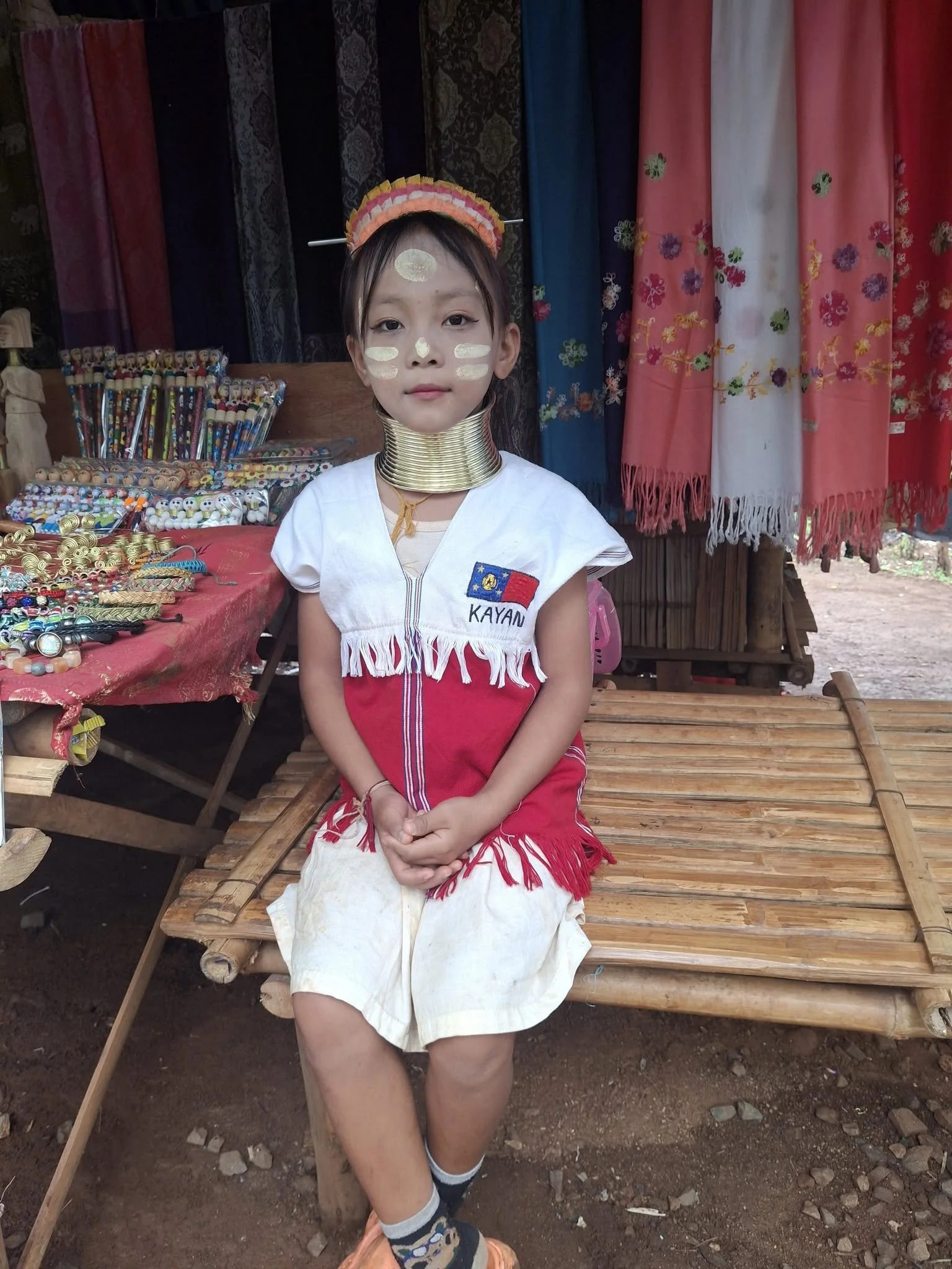Young Kayan girl in traditional dress at a village near Chiang Rai, Thailand.