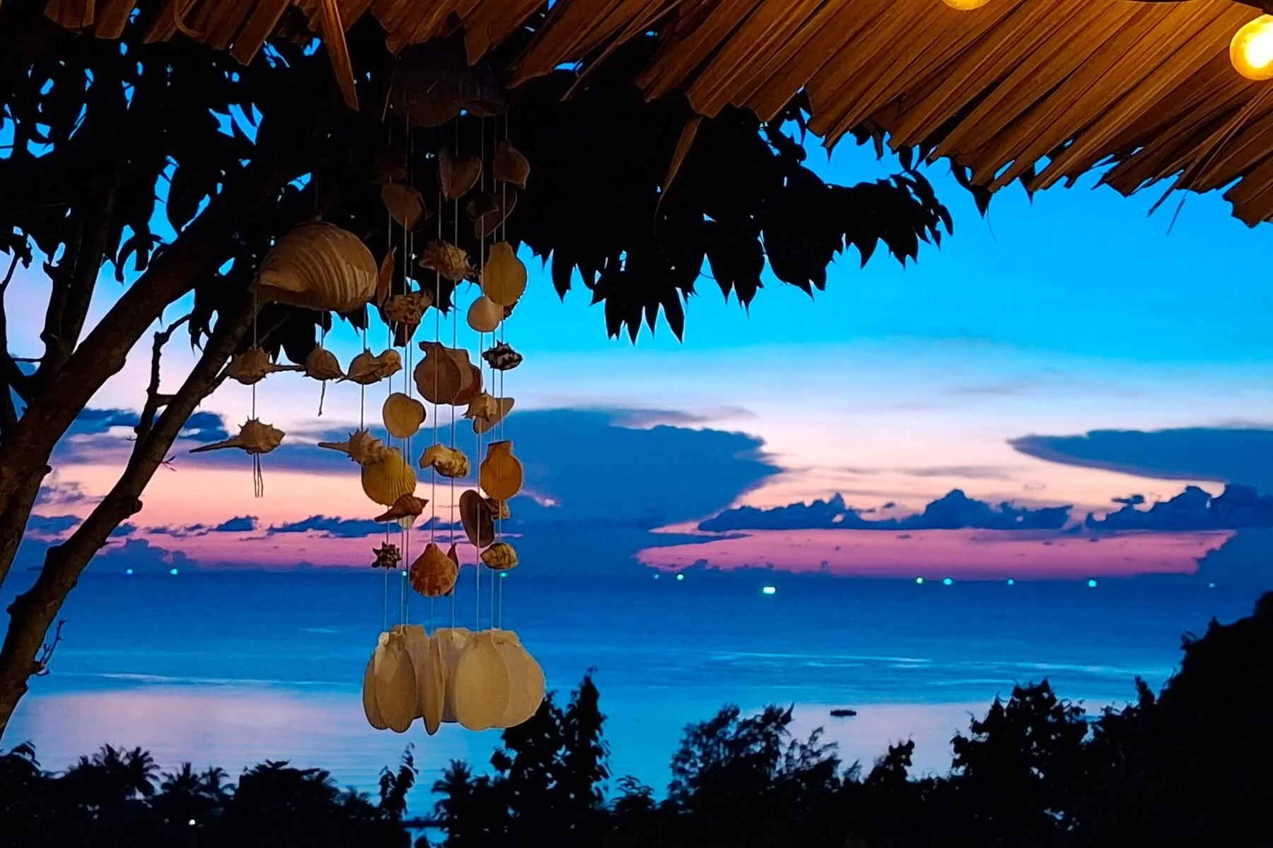 Island sunset viewed from a tropical seaside shelter