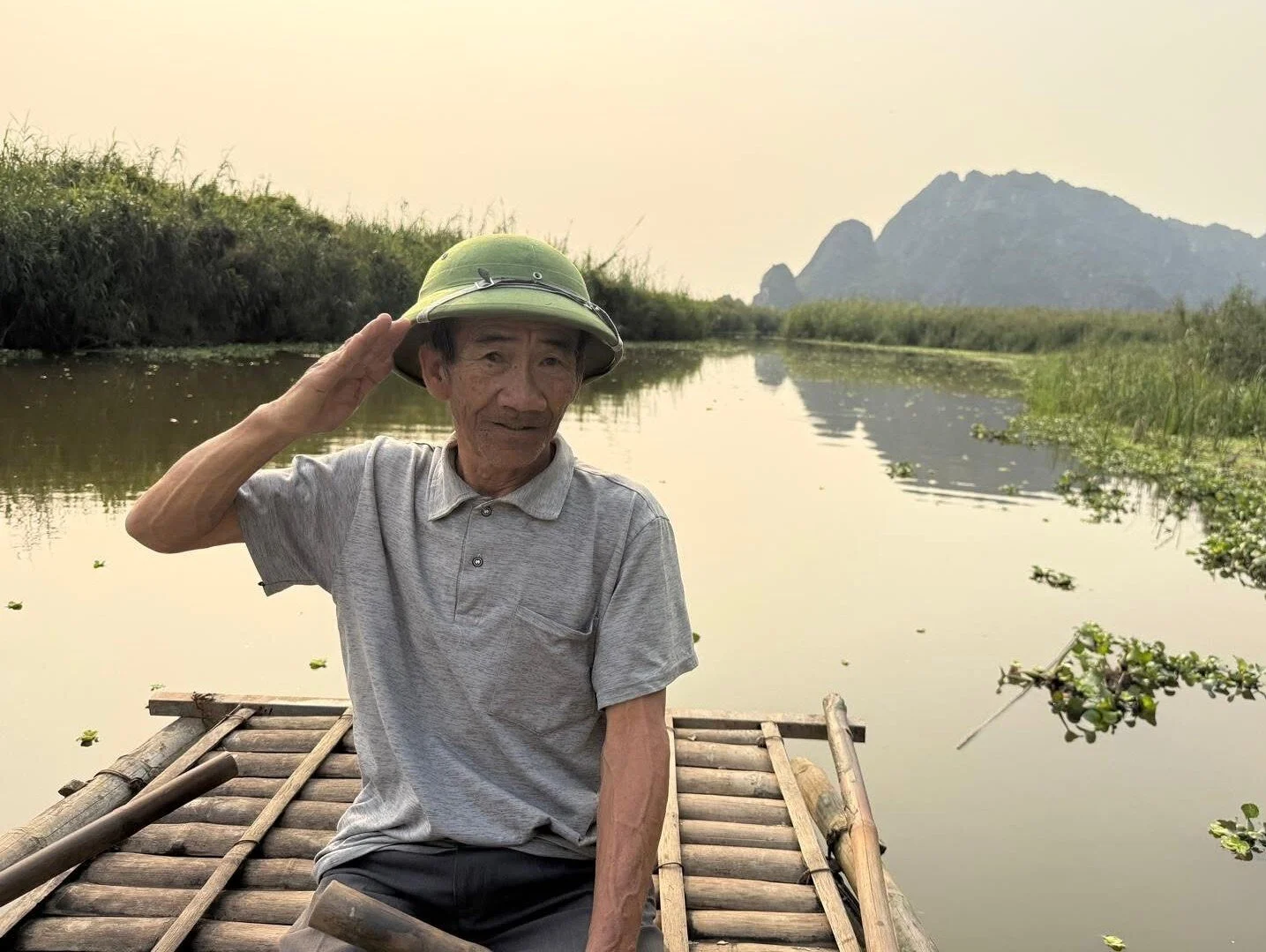 Local man sitting on a bamboo raft in Ninh Binh, Vietnam