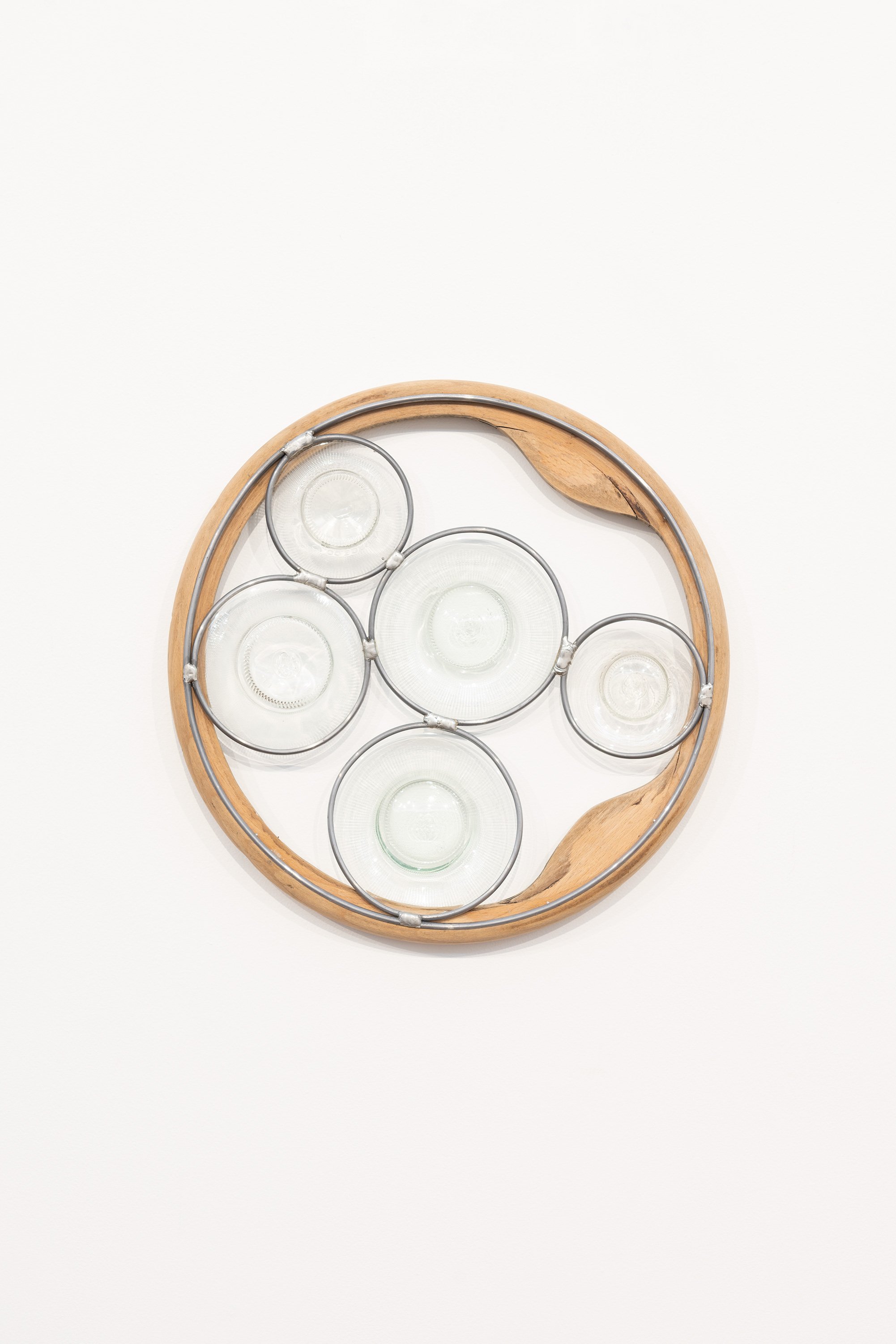 Abstract Afternoon Reflection (Strange Love, Circular), 2026. 410x70mm. Found and glued bentwood chair parts, blown and lead-lighted found glass bottles. Photographer: Gary Trinh

