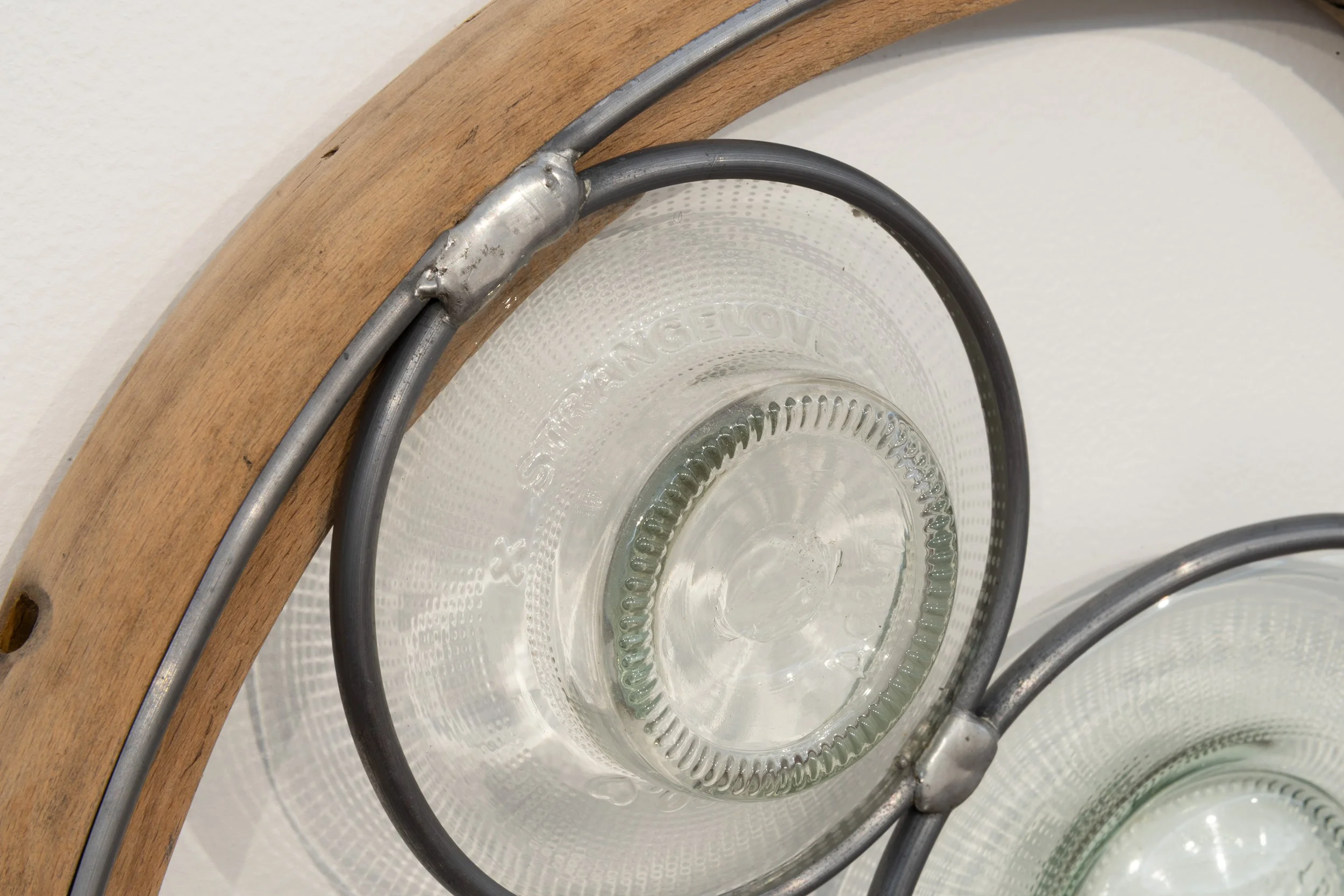 Abstract Afternoon Reflection (Strange Love, Circular), 2026. 410x70mm. Found and glued bentwood chair parts, blown and lead-lighted found glass bottles. Photographer: Gary Trinh
