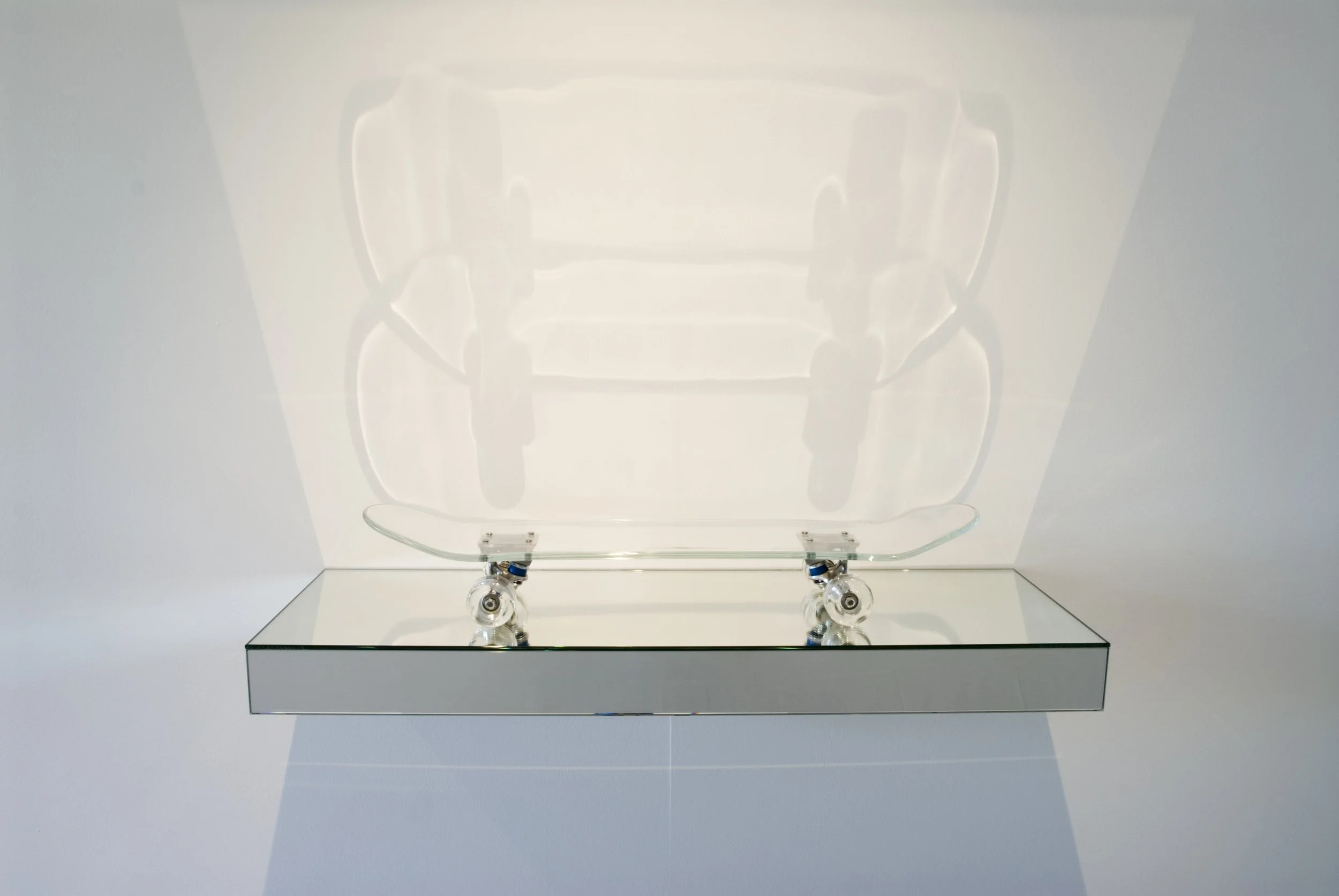 Idealised Ride, 2009, kiln and hot formed glass, skateboard trucks and bearings, mirror, wood, 900x400x140mm. Photographer: Greg Piper