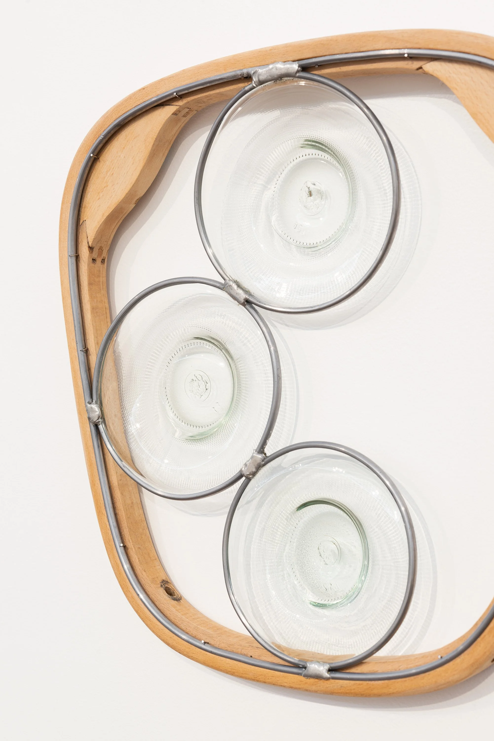 Abstract Afternoon Reflection (Partial Decant), 2026. 400x395x35mm. Found bentwood chair part, blown and lead-lighted found glass bottles.
Photographer: Gary Trinh
