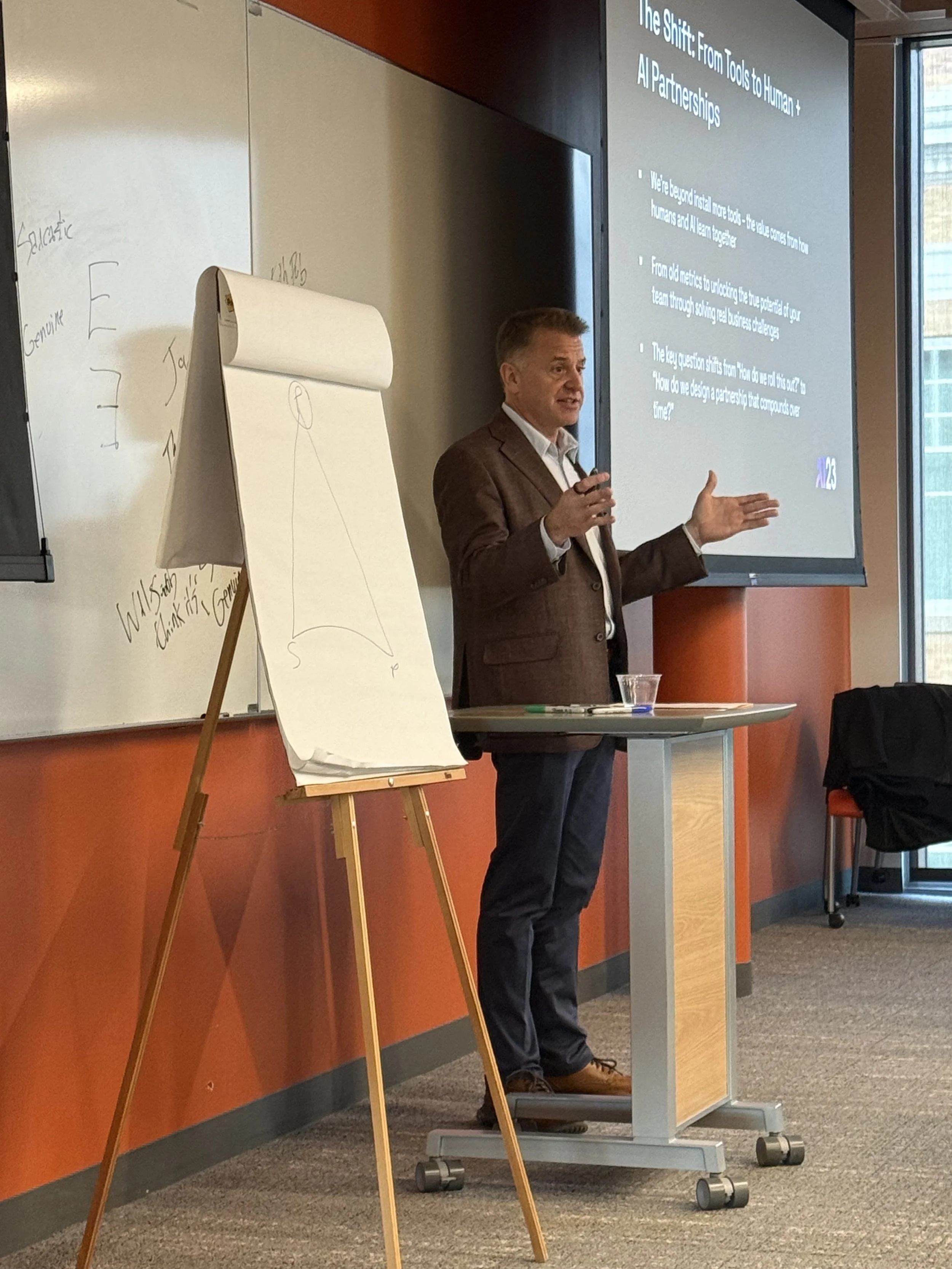 Craig Francisco speaking in front of a room of leaders talking about AI