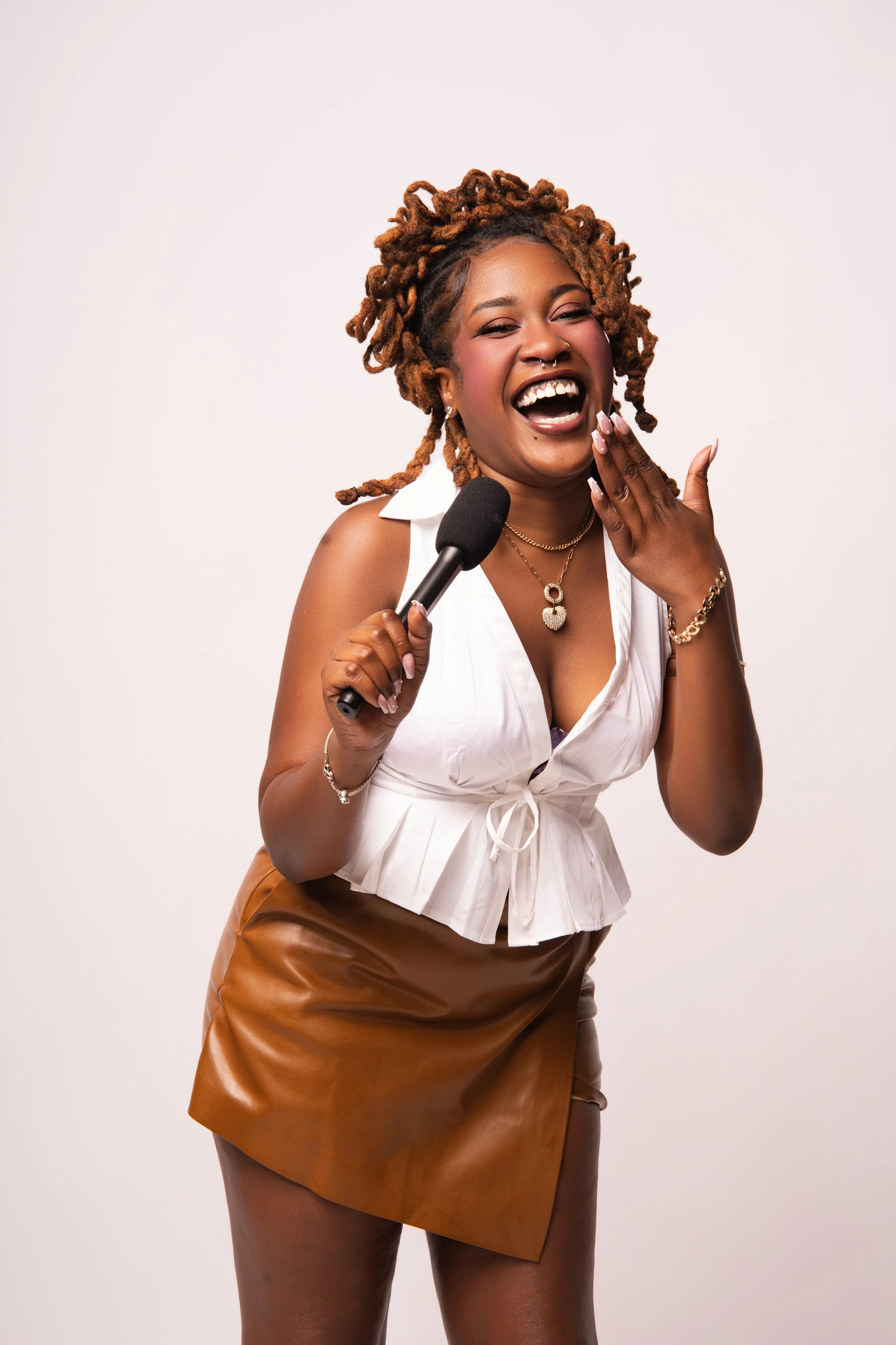 Aura Laura laughing with the Hard & Uncut microphone in hand