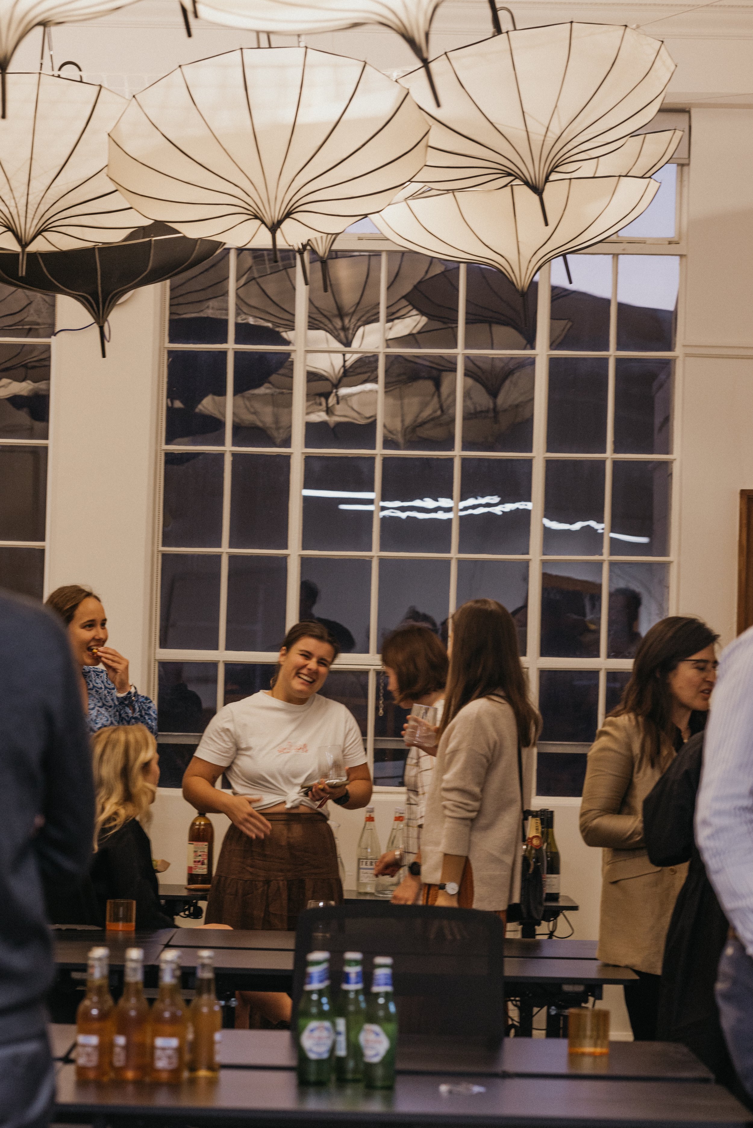 People socializing at an event held at Bad Company Hawkes Bay, a co-working space based in Hastings, New Zealand. 