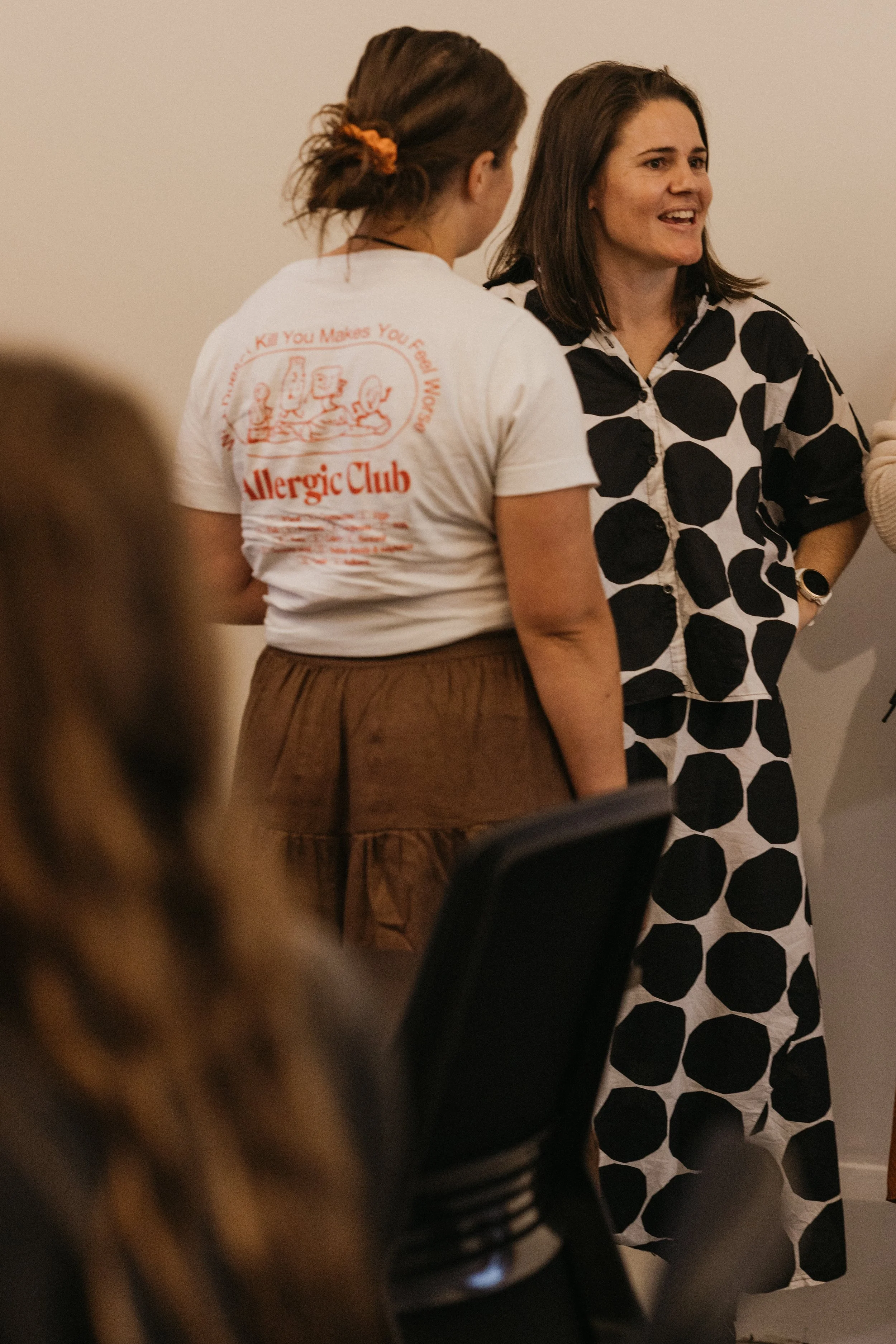 Two women are engaged in conversation at an event held at Bad Company Hawkes Bay, a co-working space based in Hastings, New Zealand. 