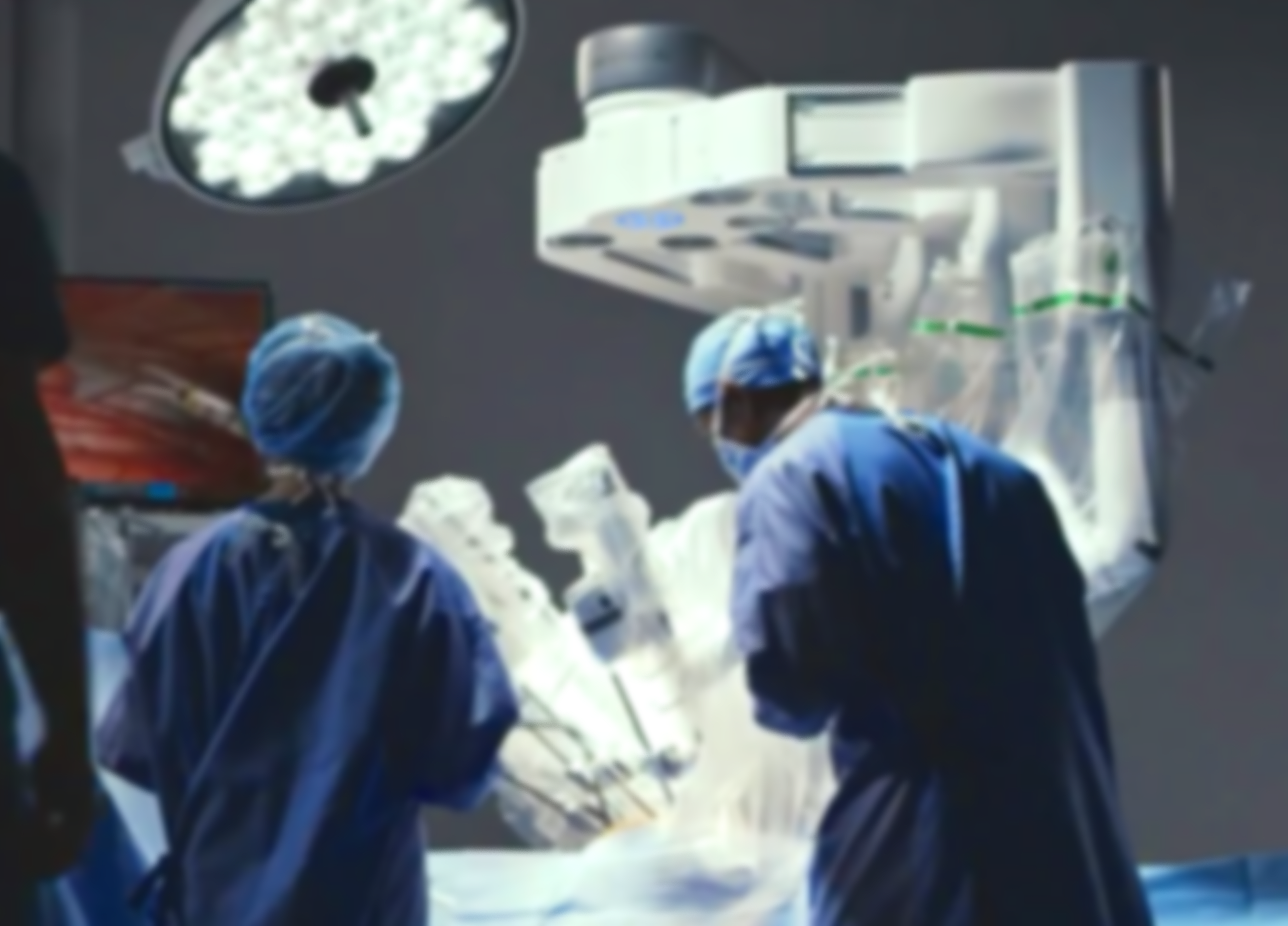 Surgeons performing a surgery in an operating room with surgical lights overhead.