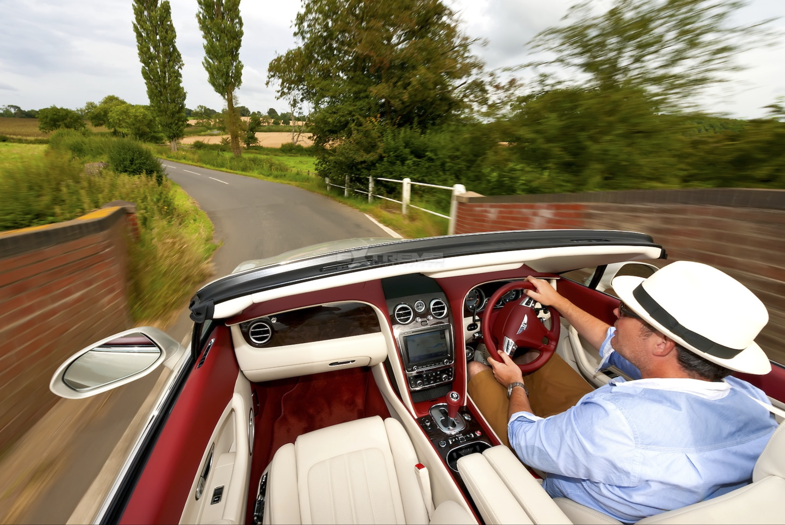 Car photography by David Spurdens of RAPT TV here a convertible Bentley being driven through countryside