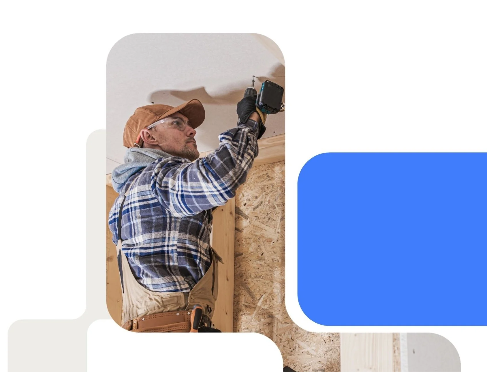 A man wearing a brown cap, transparent glasses, a plaid shirt, and work gloves using a power drill on a ceiling during construction or renovation.