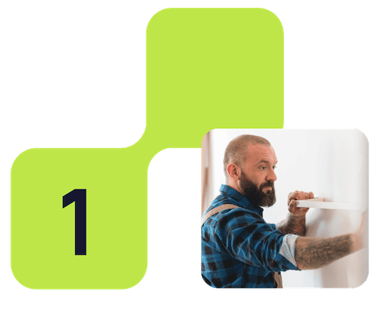 A graphic with a green background and a large number one, accompanied by a photo of a man with a beard and tattoos, wearing a blue checkered shirt, looking at a wall. Step 1 - find a tradesperson.