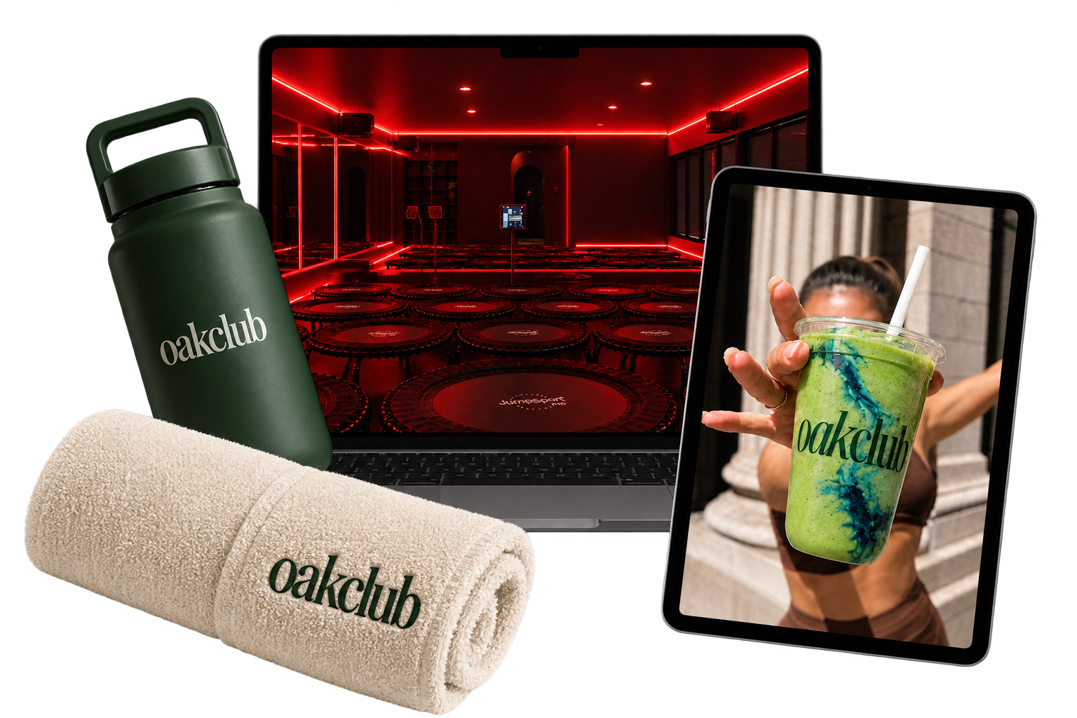 A collection of fitness and wellness items branded with 'oakclub,' including a green water bottle, a rolled white towel, and a green smoothie in a clear cup held by a person. A laptop and a tablet display a red-lit indoor workout space with mini trampolines and exercise equipment.