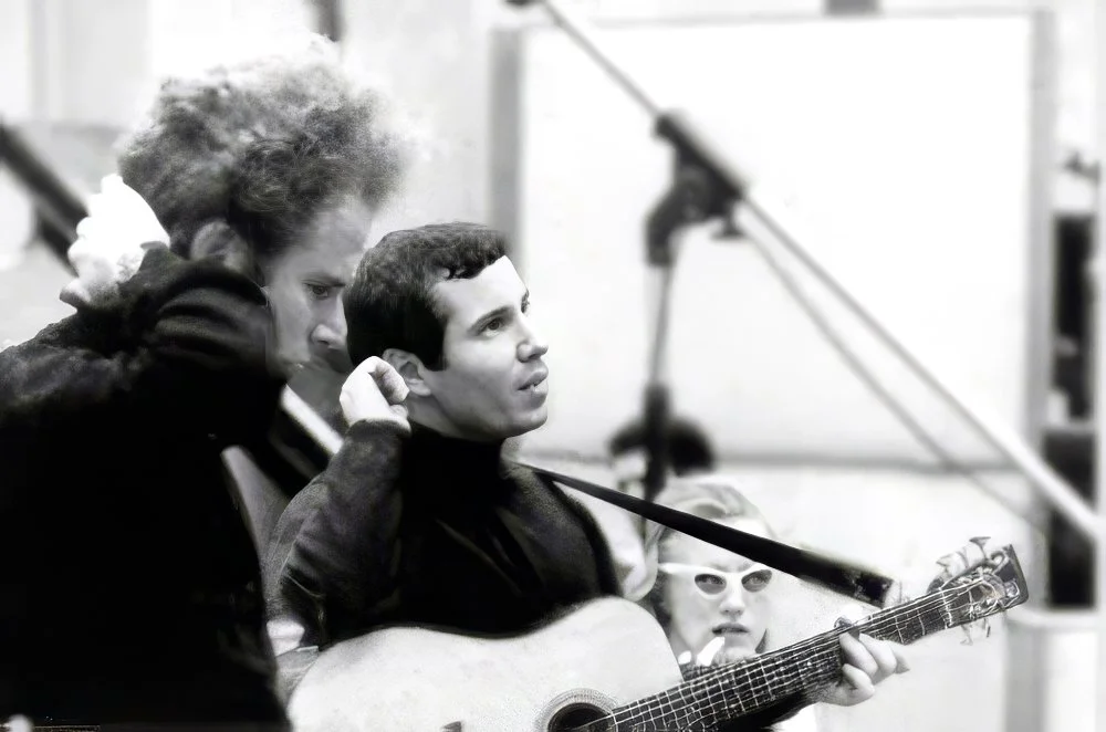 Simon & Garfunkel record date, mid-'60s
Art, Paul, and Carol listen to a playback.	