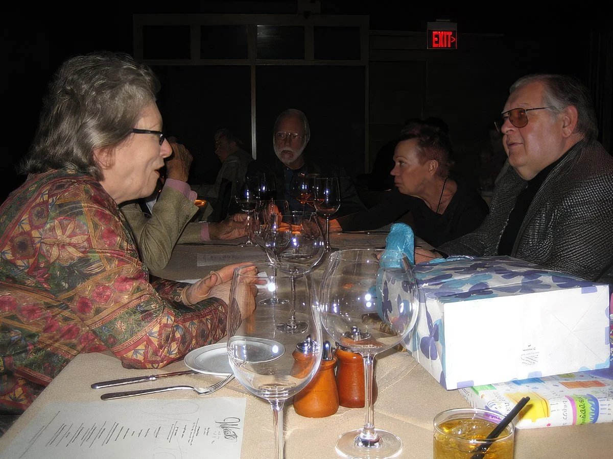 Carol and Alf Clausen chatting at the notorious birthday bash.