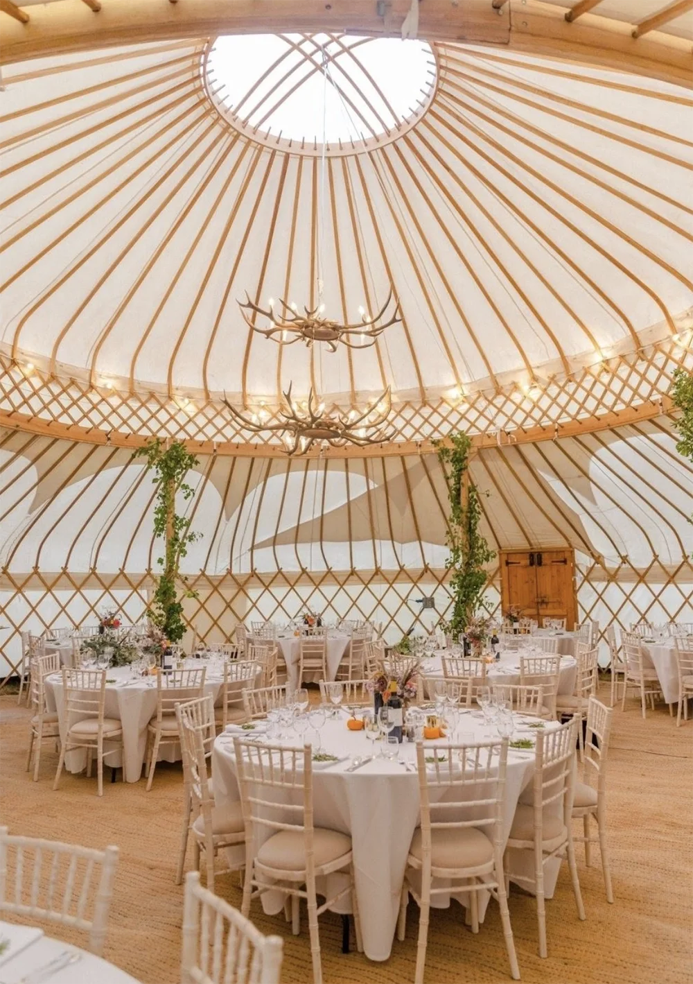 A wedding yurt with round tables for a wedding reception