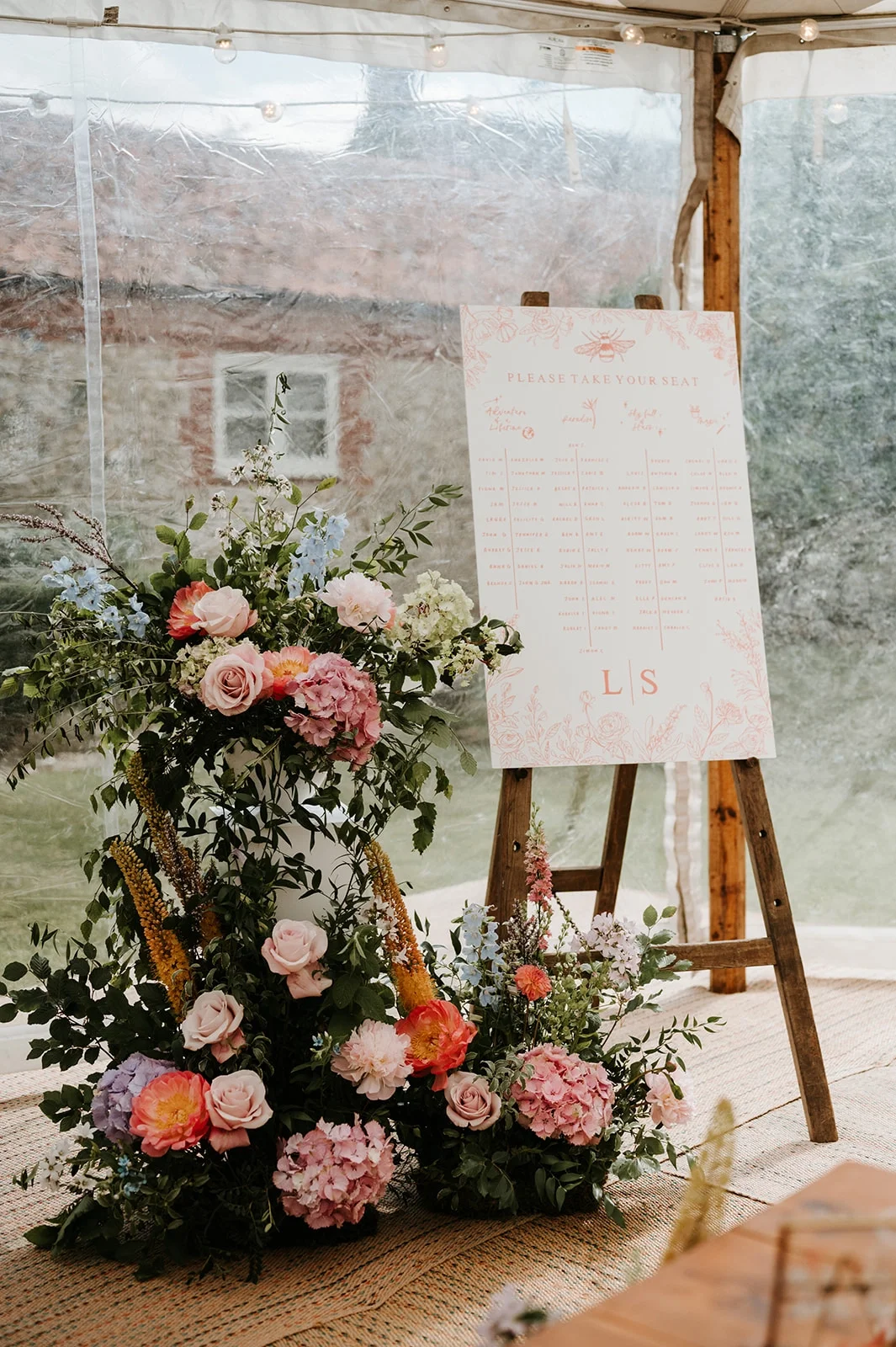 Seating plan with garden flowers at a wedding reception at a family home in Norfolk