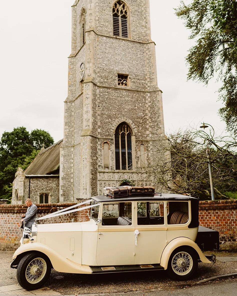 A vintage wedding car outside a Norfolk country church