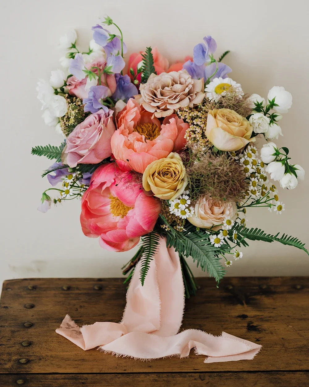 A natural bridal bouquet with peonies and roses