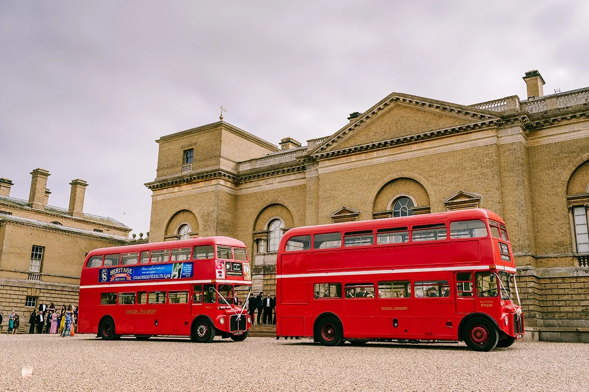 A vintage London bus transporting guests to a wedding at Holkham Hall in North Norfolk