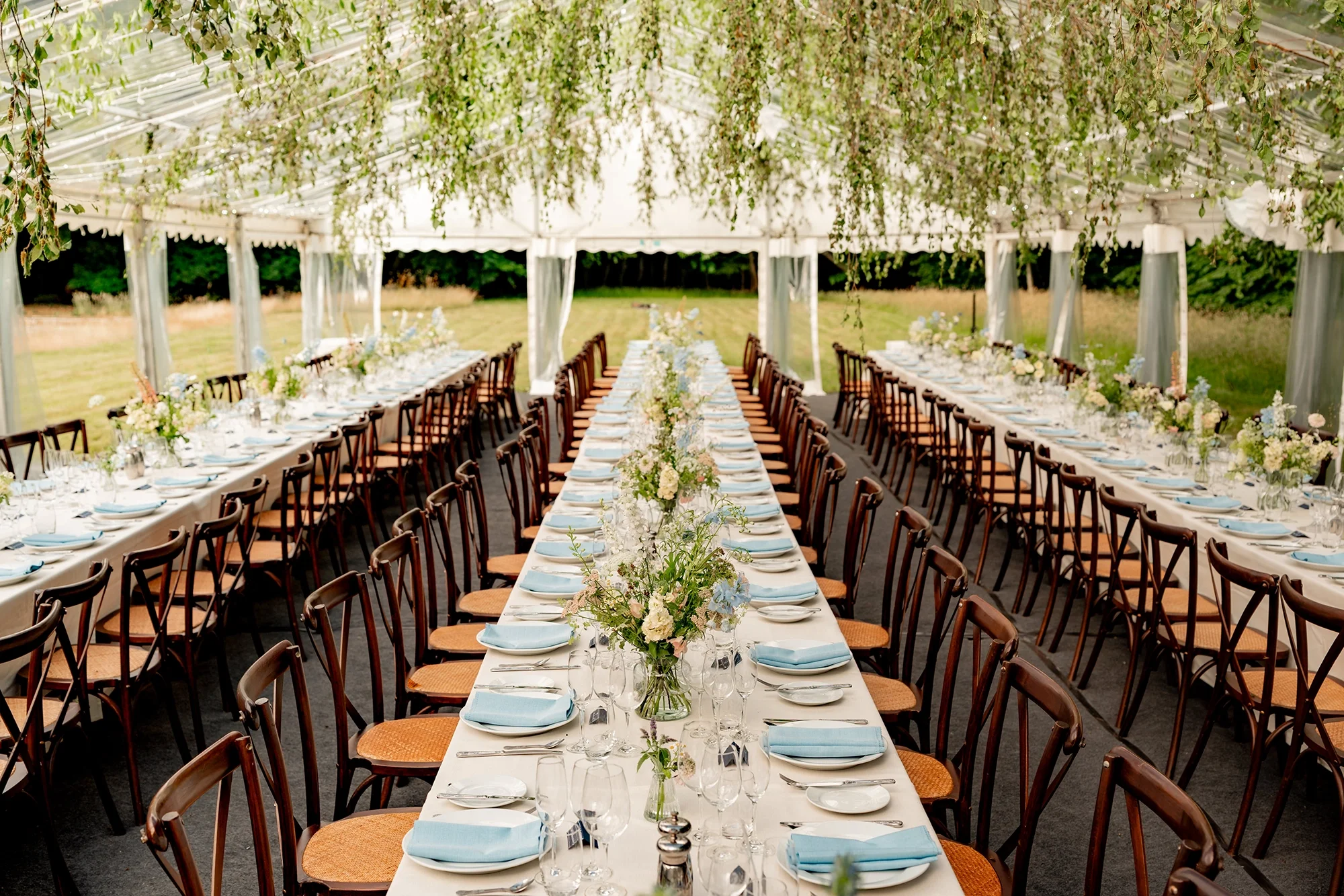 A dramatic marquee styled with foliage for a wedding at Voewood in North Norfolk