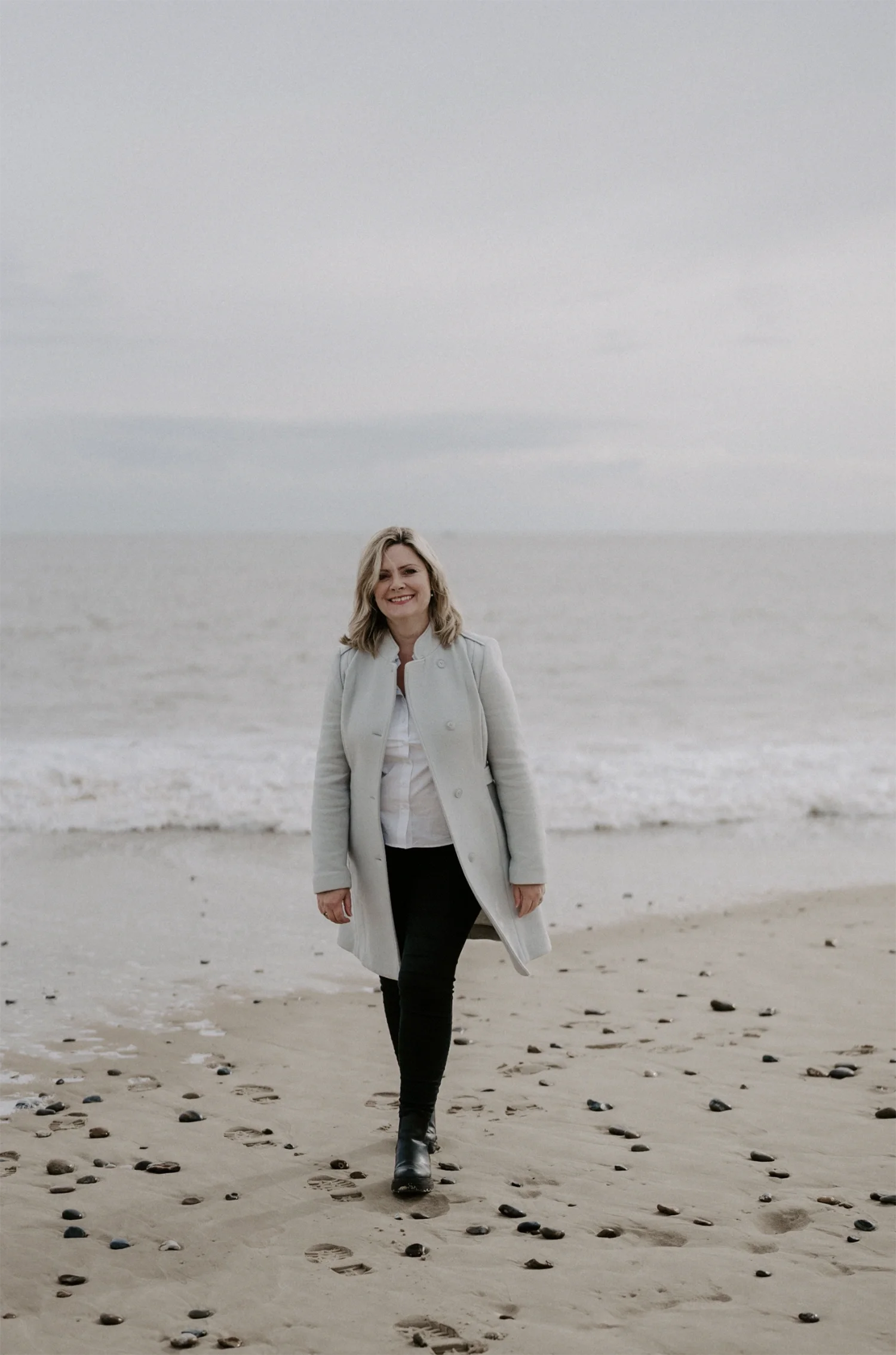 Portrait of Norfolk and Suffolk wedding planner, Emily Andrew on a Norfolk beach