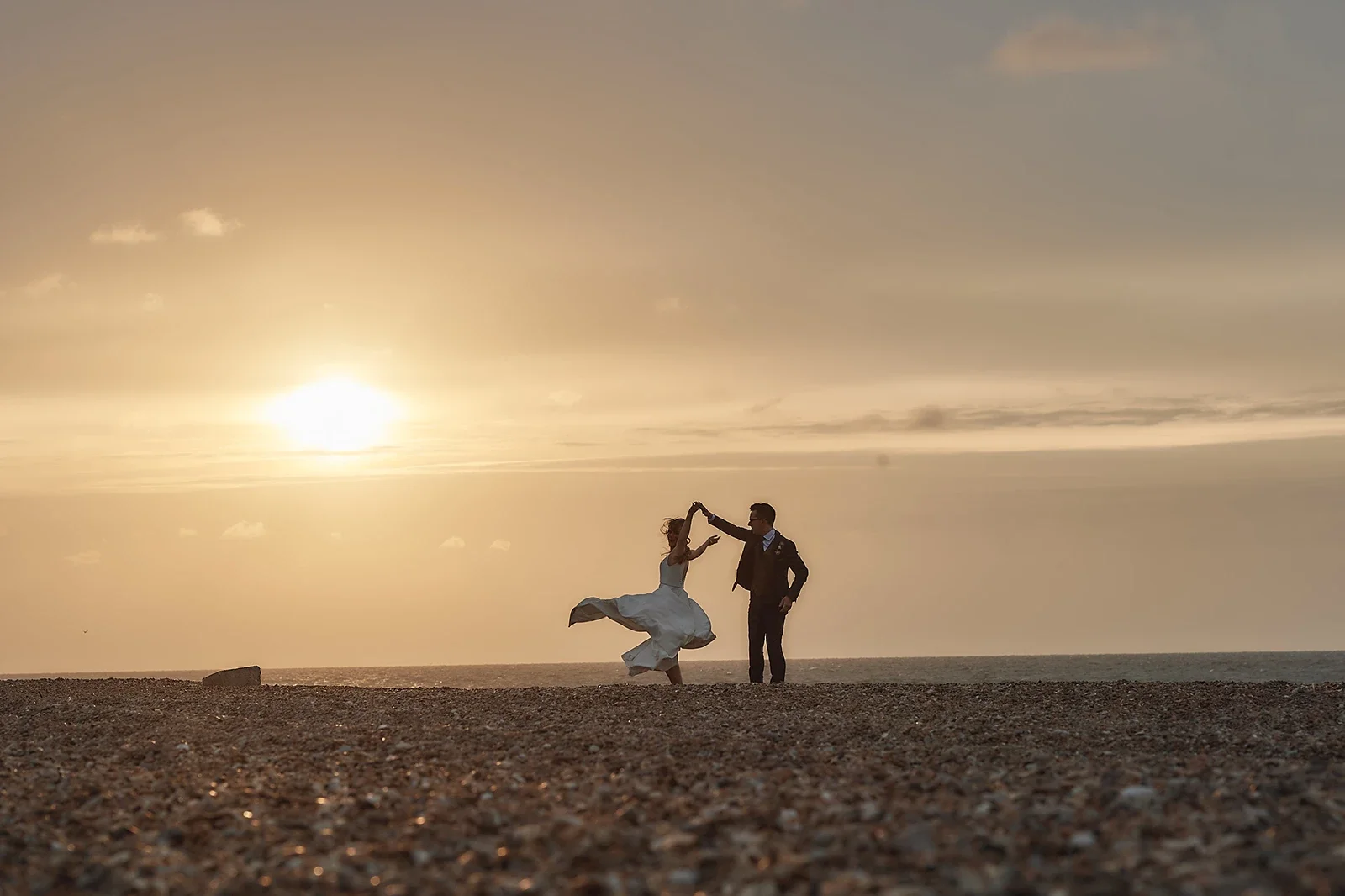 A couple at sunset on one of Norfolk's stunning beaches