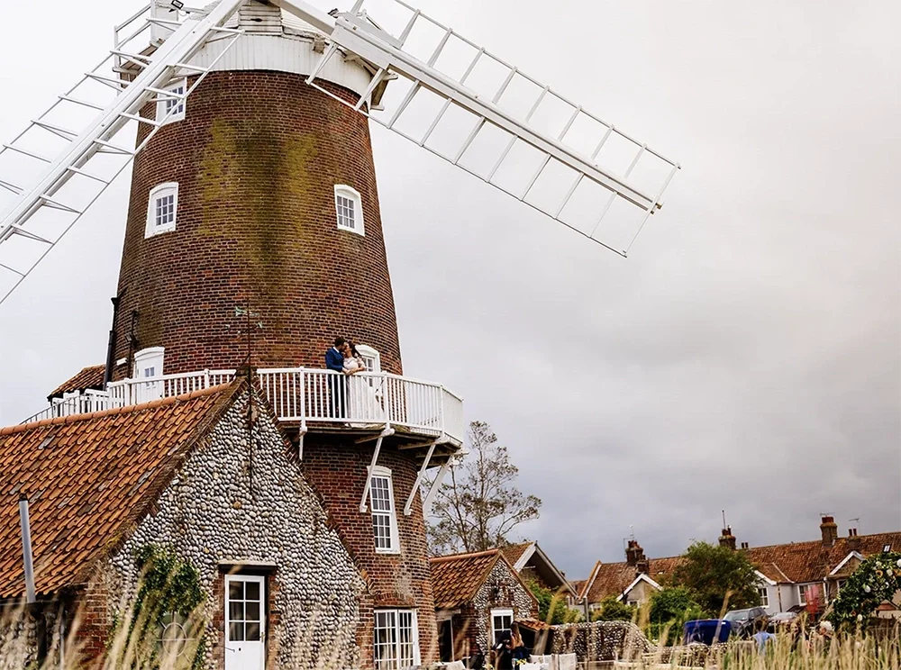 A newly wed couple at their wedding at Cley Windmill in North Norfolk
