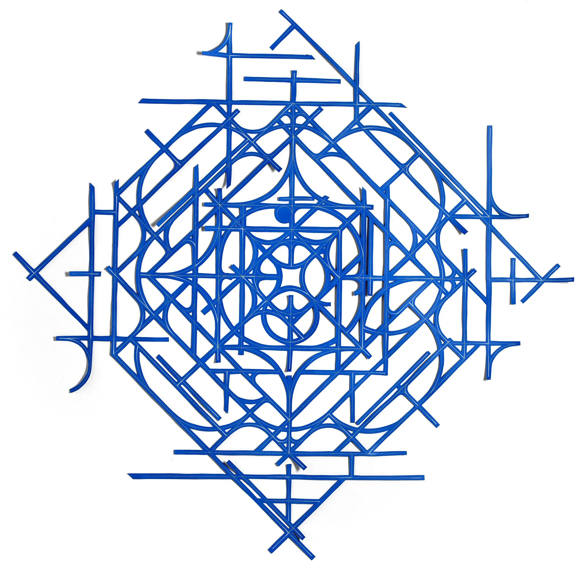 abstract geometric mandala artwork from cut blue paper on a white wall