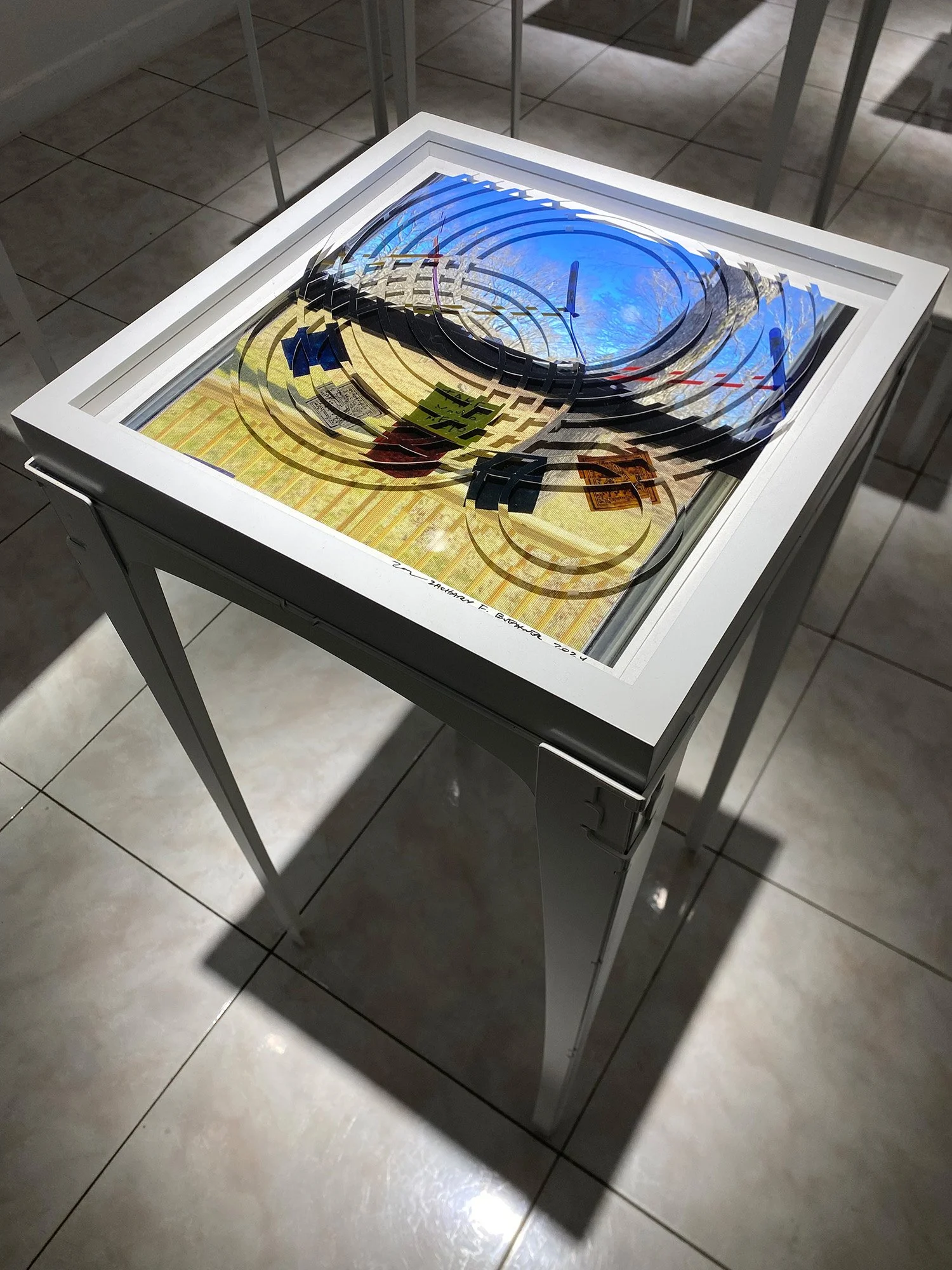 photo collage on table of a window where photo looks agitated by rain drops on water