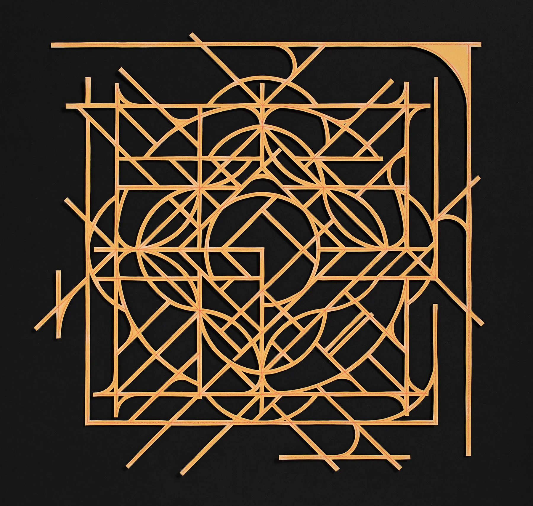 abstract geometric mandala artwork from cut yellow paper on a black surface