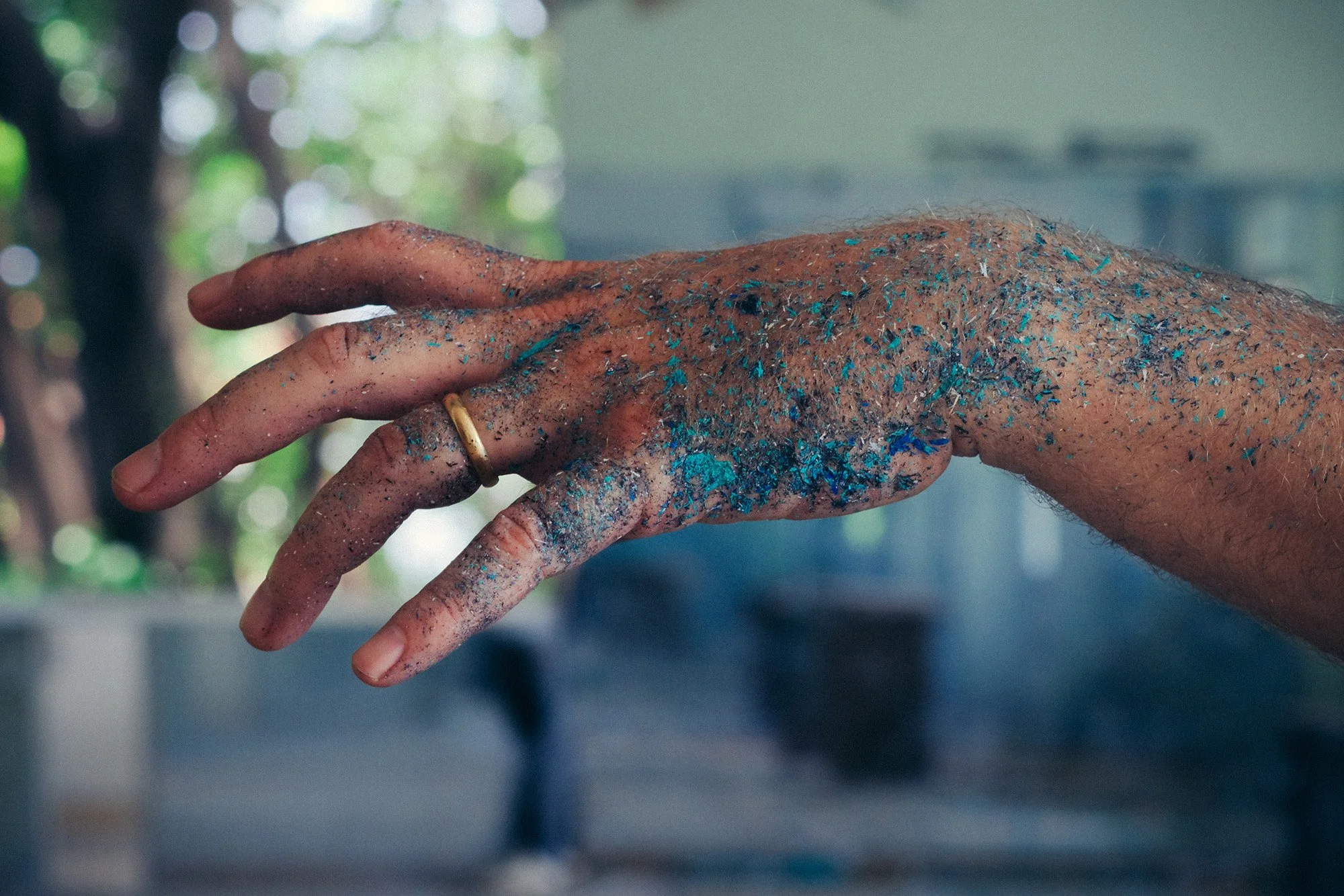 a hand posed covered in paint