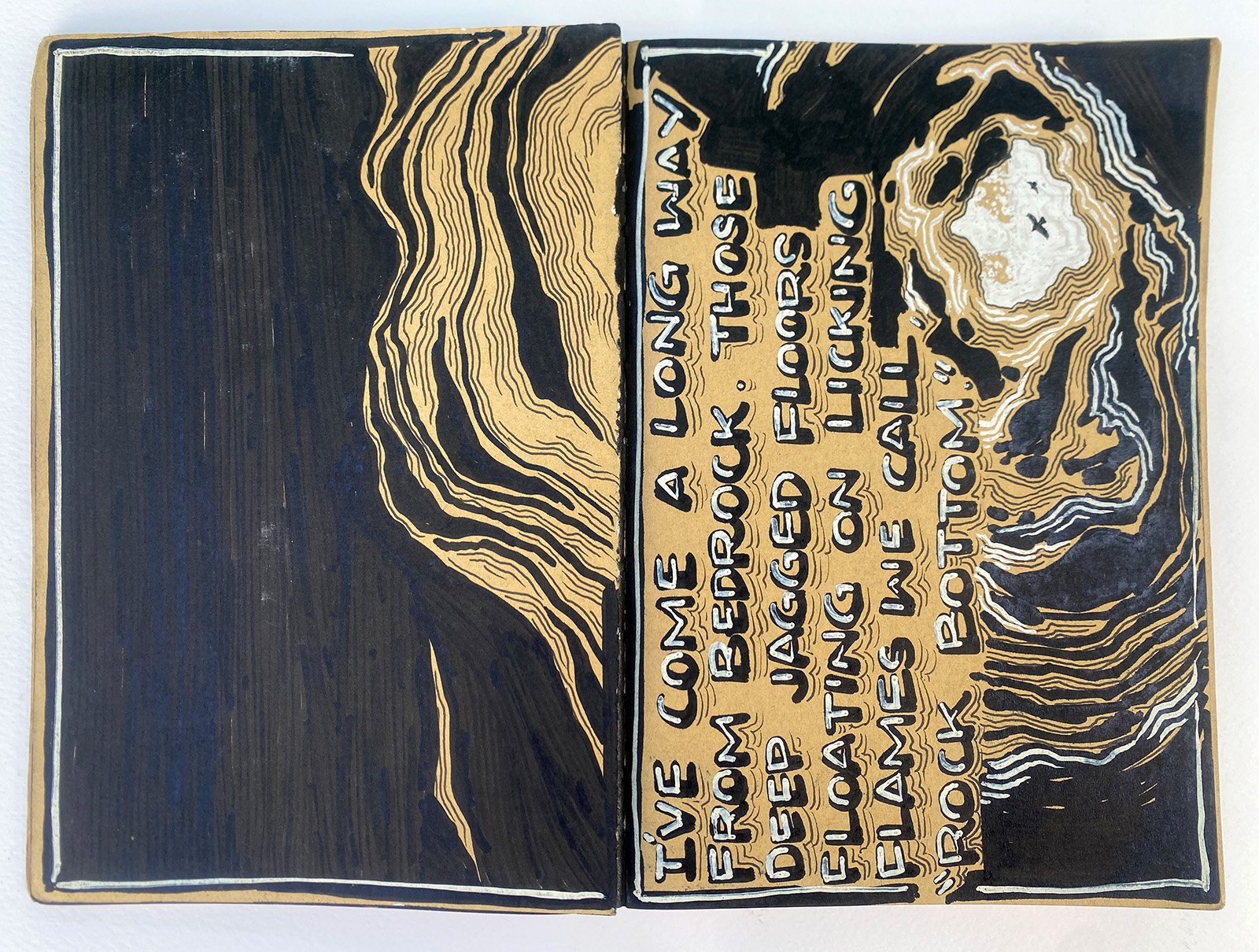 An illustration looking up from the bottom of a cave with intricate line patterns and a handwritten message inside.