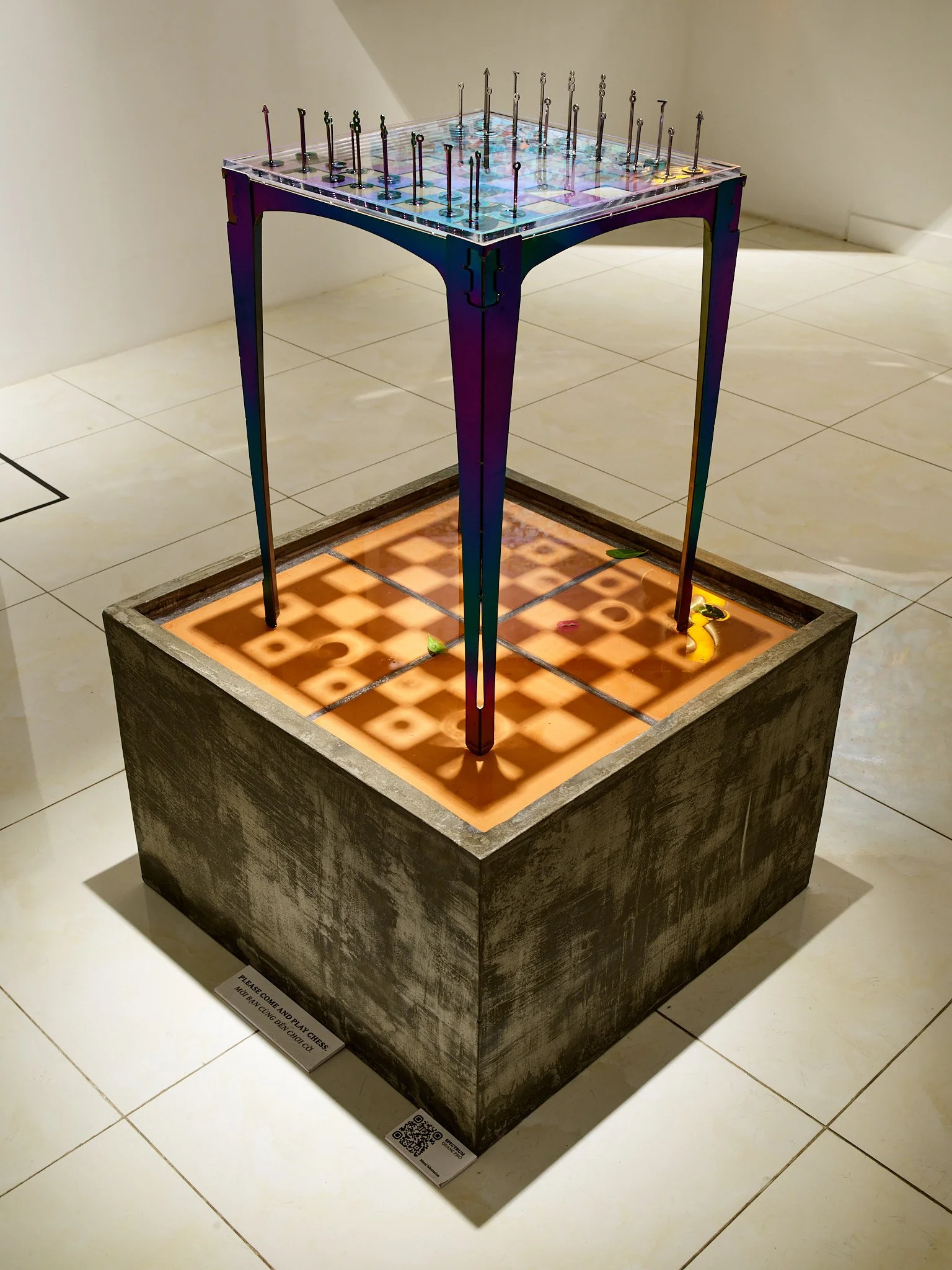 sculptural chess table filled with water on a tiled base also filled with water in gallery