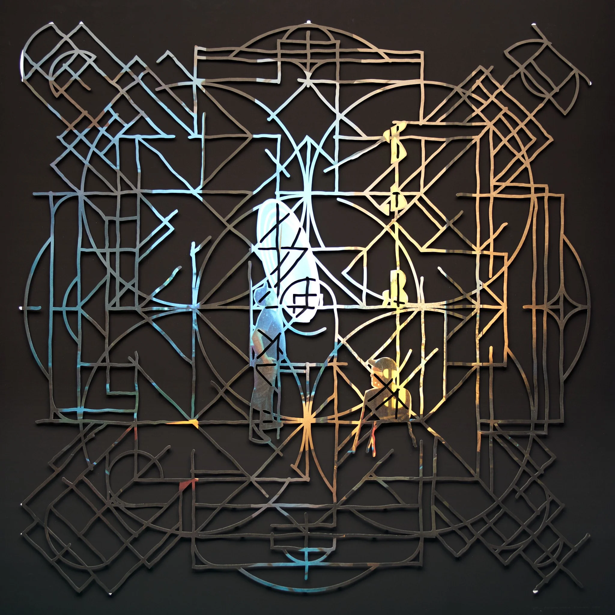 abstract geometric mandala artwork from cut  photograph on a black surface