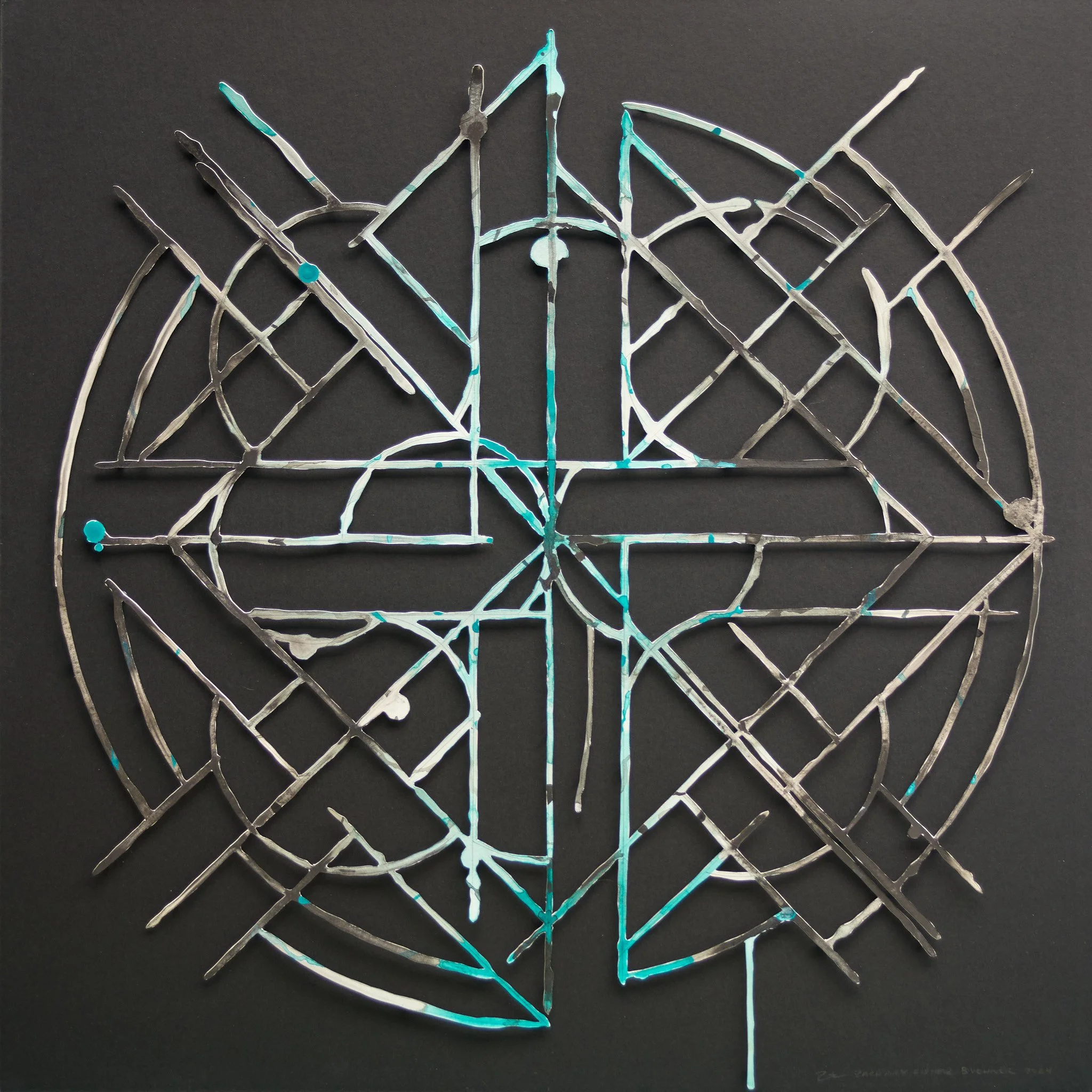 abstract geometric mandala artwork from cut grey and green paper on a black surface