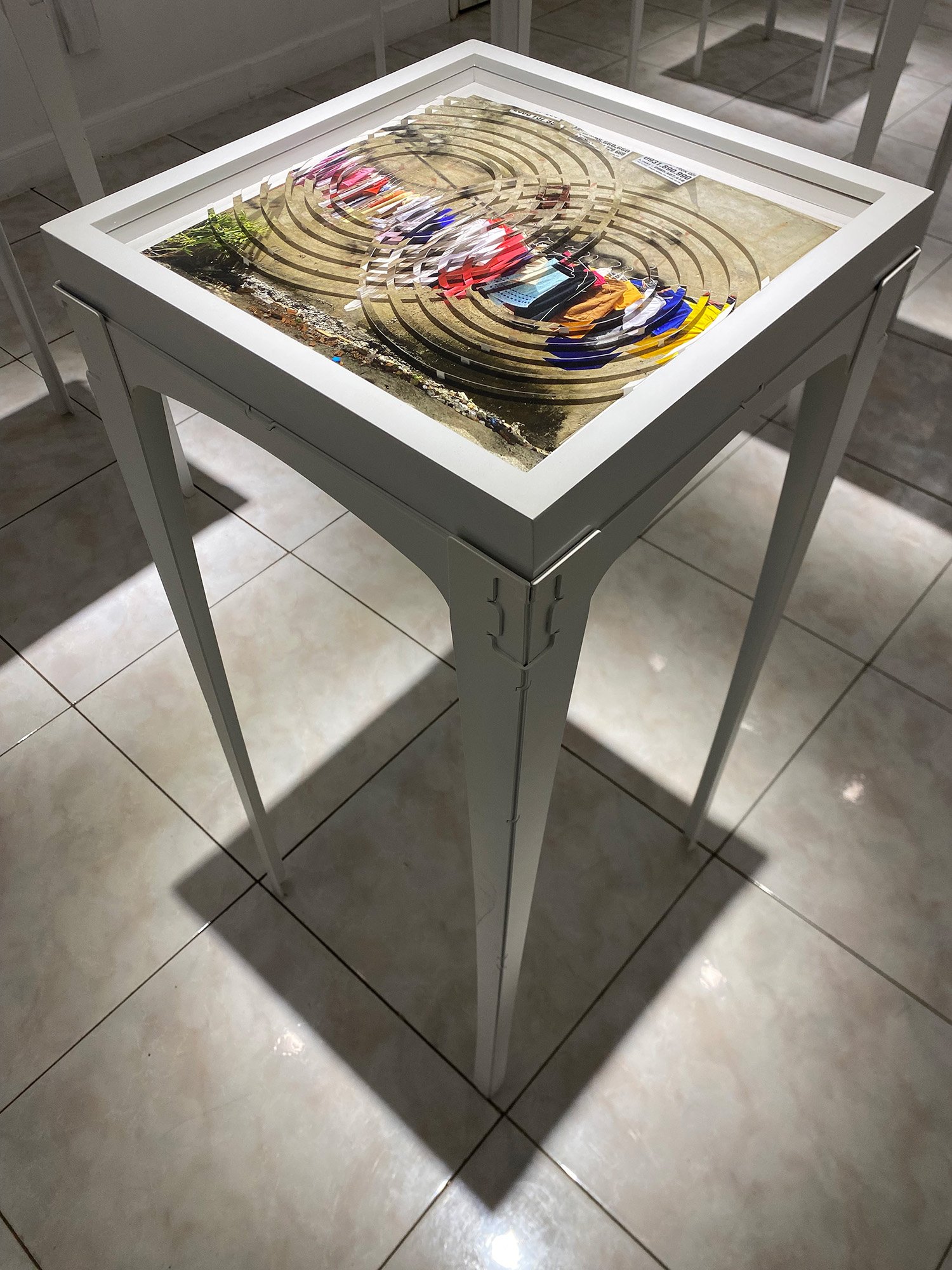 photo collage on table of hanging laundry where photo looks agitated by rain drops on water