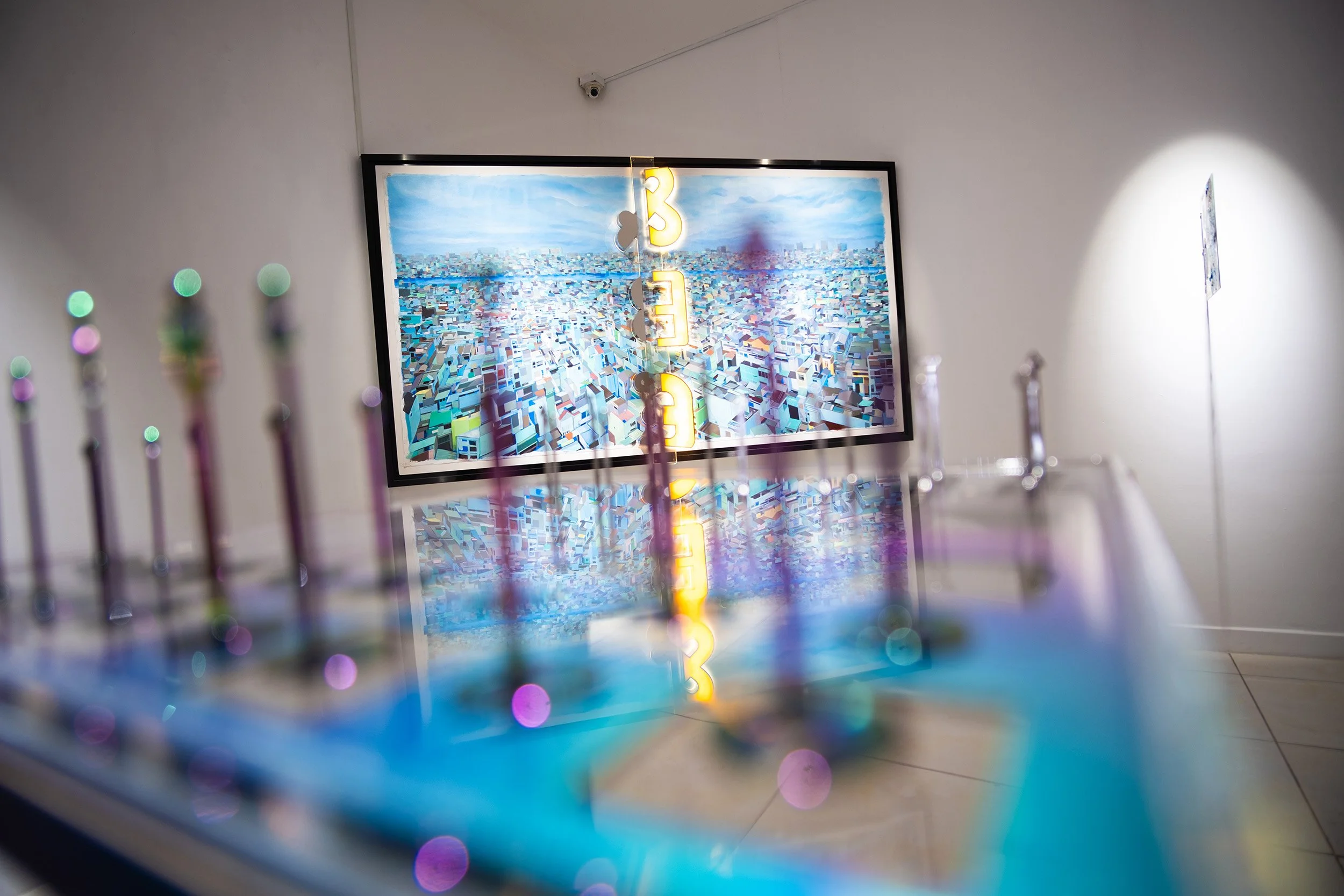 blue painting of rooftops in the background with blurred chess set in front