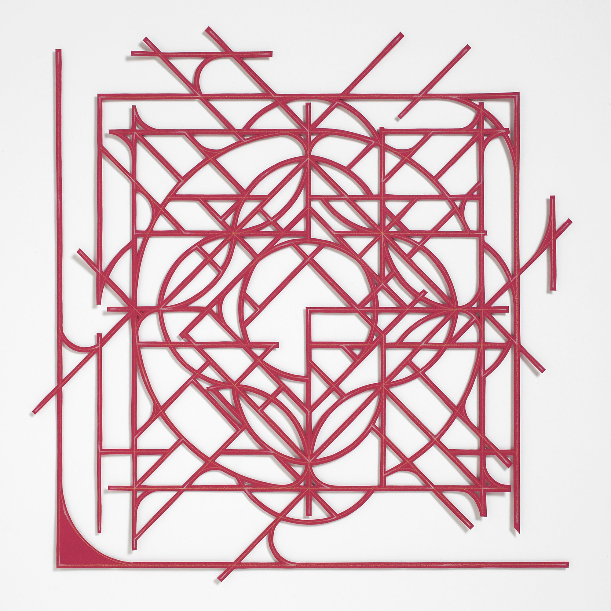 abstract geometric mandala artwork from cut red paper on a white wall