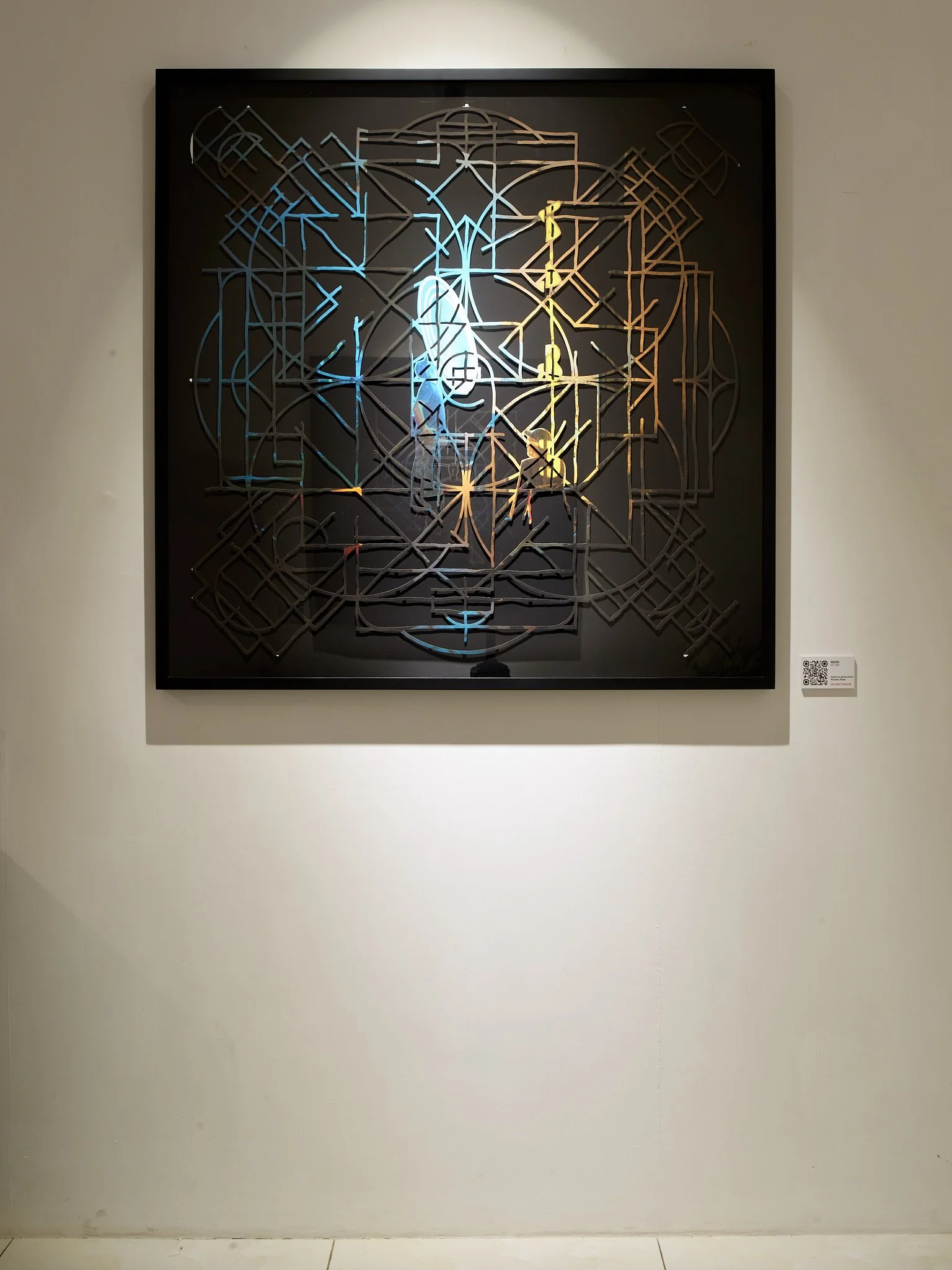 abstract geometric mandala framed on gallery wall